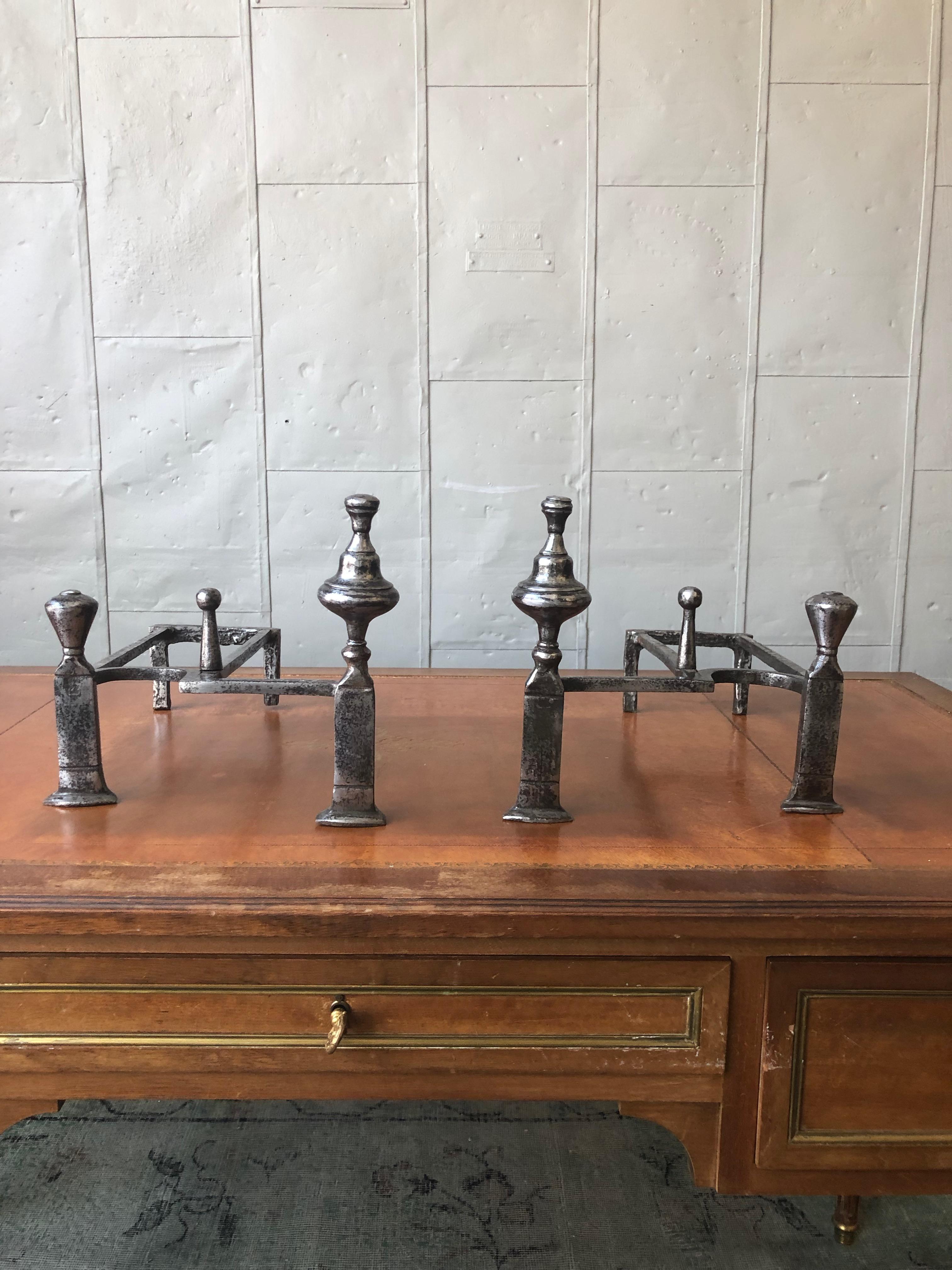 An unusual pair of Art Deco style andirons in polished iron. Each piece has double finials on the front as well as a lower center finial. The andirons have recently been polished. Good vintage condition.

Ref #: D0819-04

Dimensions: 9 ¾”H x 10 ½”W