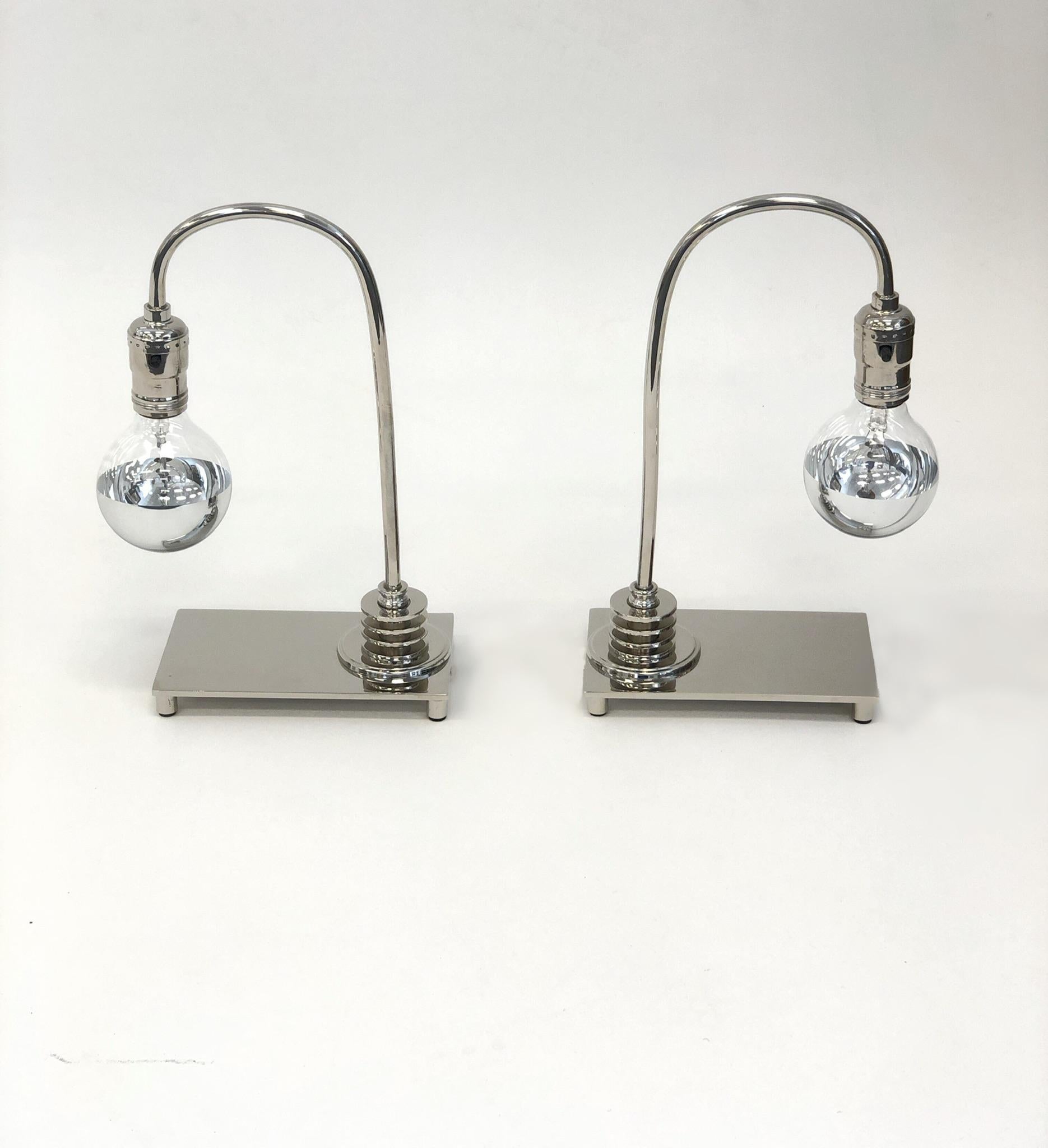 A beautiful pair of polish nickel Art Deco table lamps. The lamps have been newly nickel-plated and rewired. The light bulbs are half chrome dipped bulbs.
Dimension: 12.25” high, 8” wide, 4” deep.