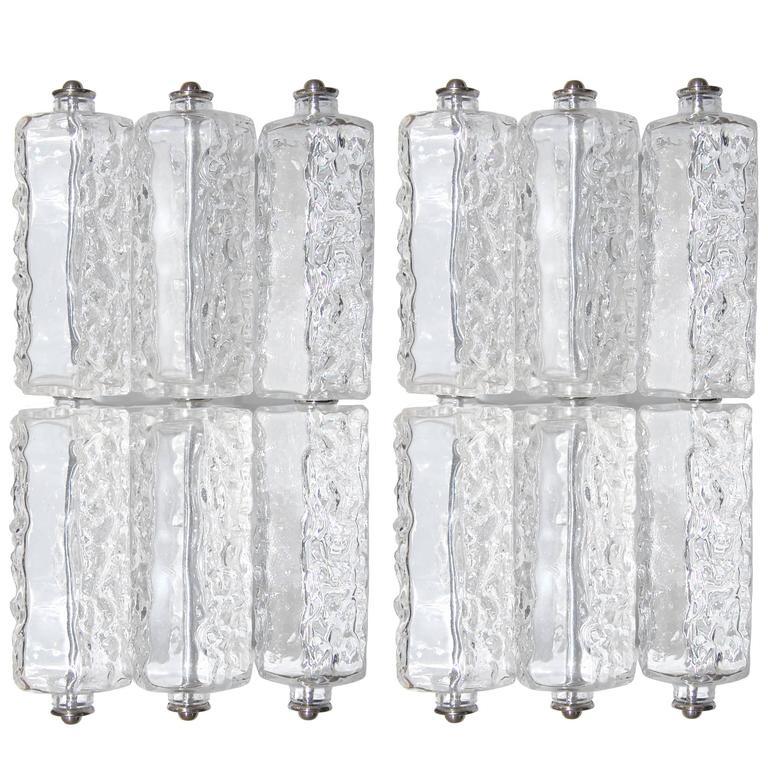 A pair of textured and smooth glass sconces with polished nickel hardware in the style of J. T. Kalmar.

Austria, Circa 1960's

Attributed to Hillebrand or Kaiser