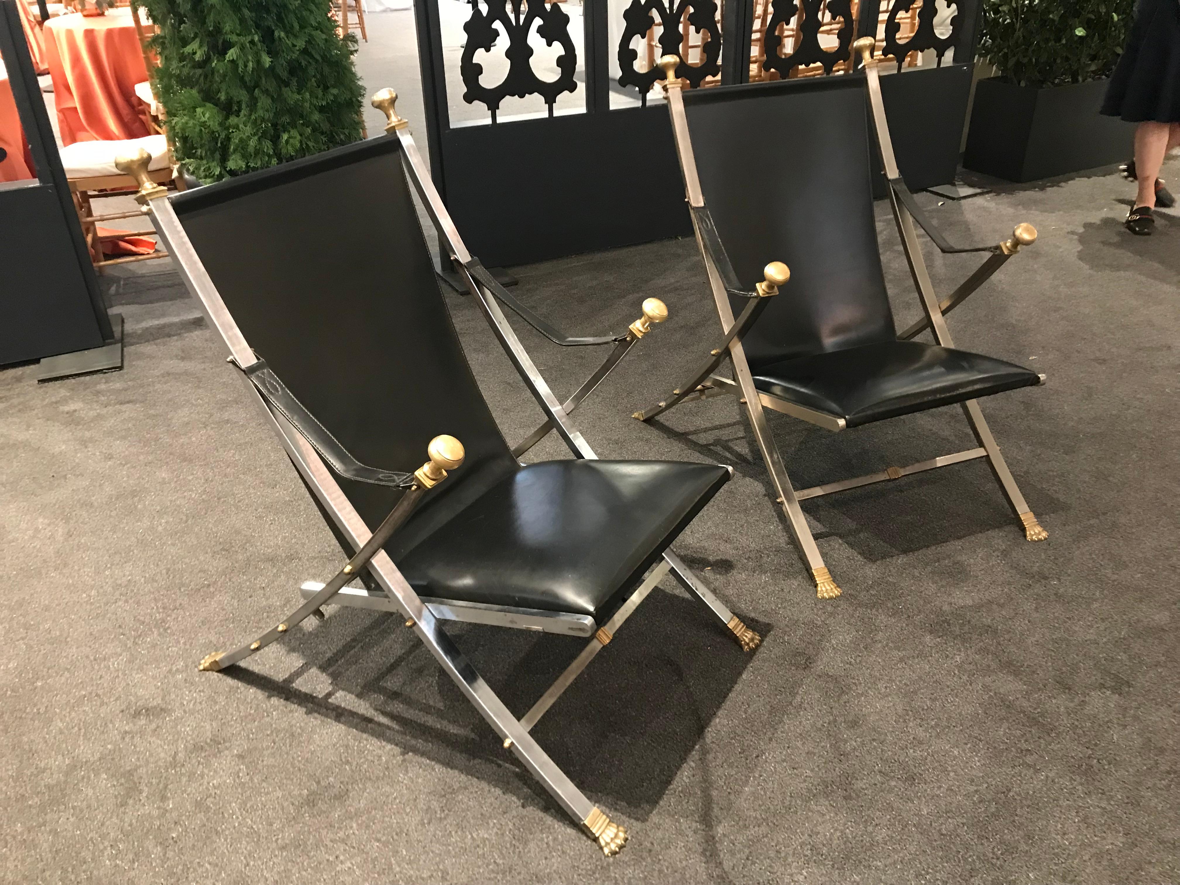 Pair of polished steel and leather folding chairs in the style of Maison Jansen. Stamped: Italy.
  