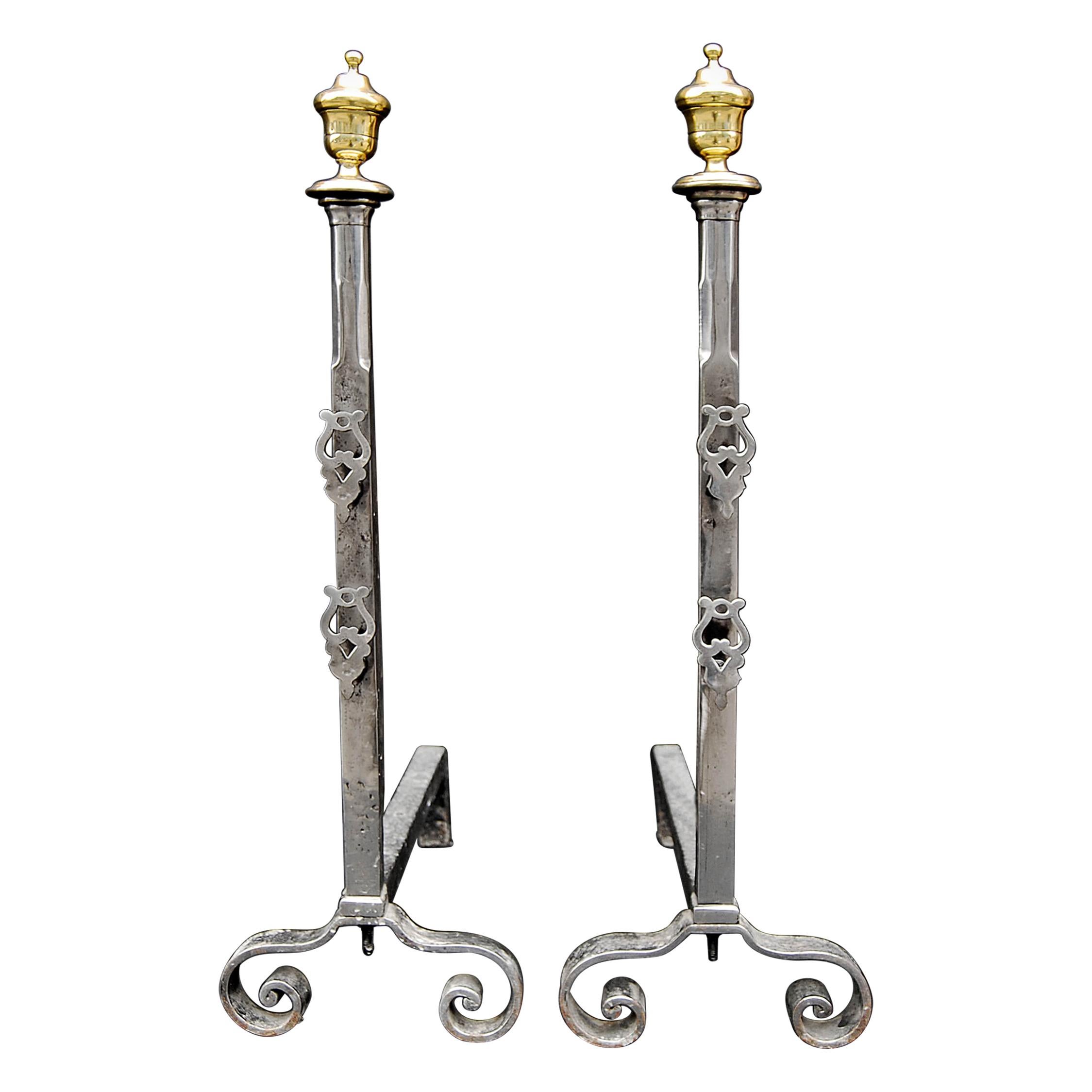 Pair of Polished Steel Firedogs with Brass Urn Finials For Sale