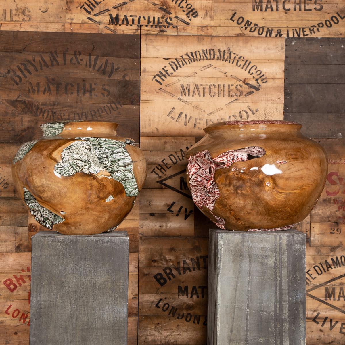 Two large wooden pots on stands, painted inside following the natural grain of the trees root and outside contrasts with the highly polished natural wood.

Measures: Height 190 and 166cm
Diameter 50 and 44cm.