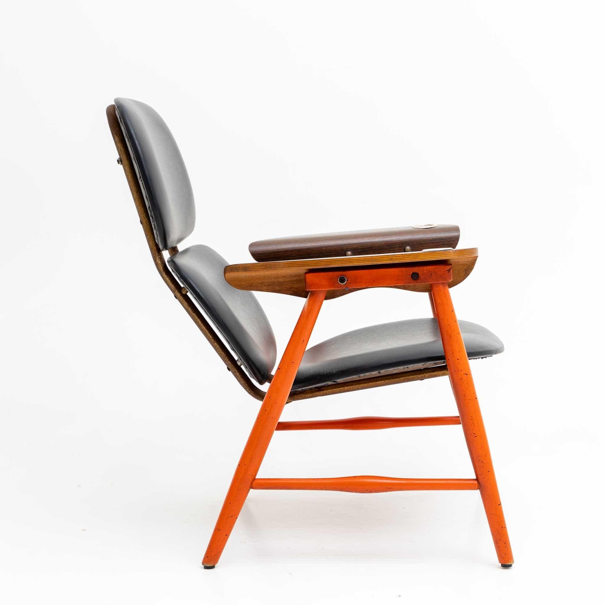 Pair of Poltronova armchairs with red lacquered frame, veneered armrests and three-piece seat covered with black leather. In the armrests are embedded small ashtrays.