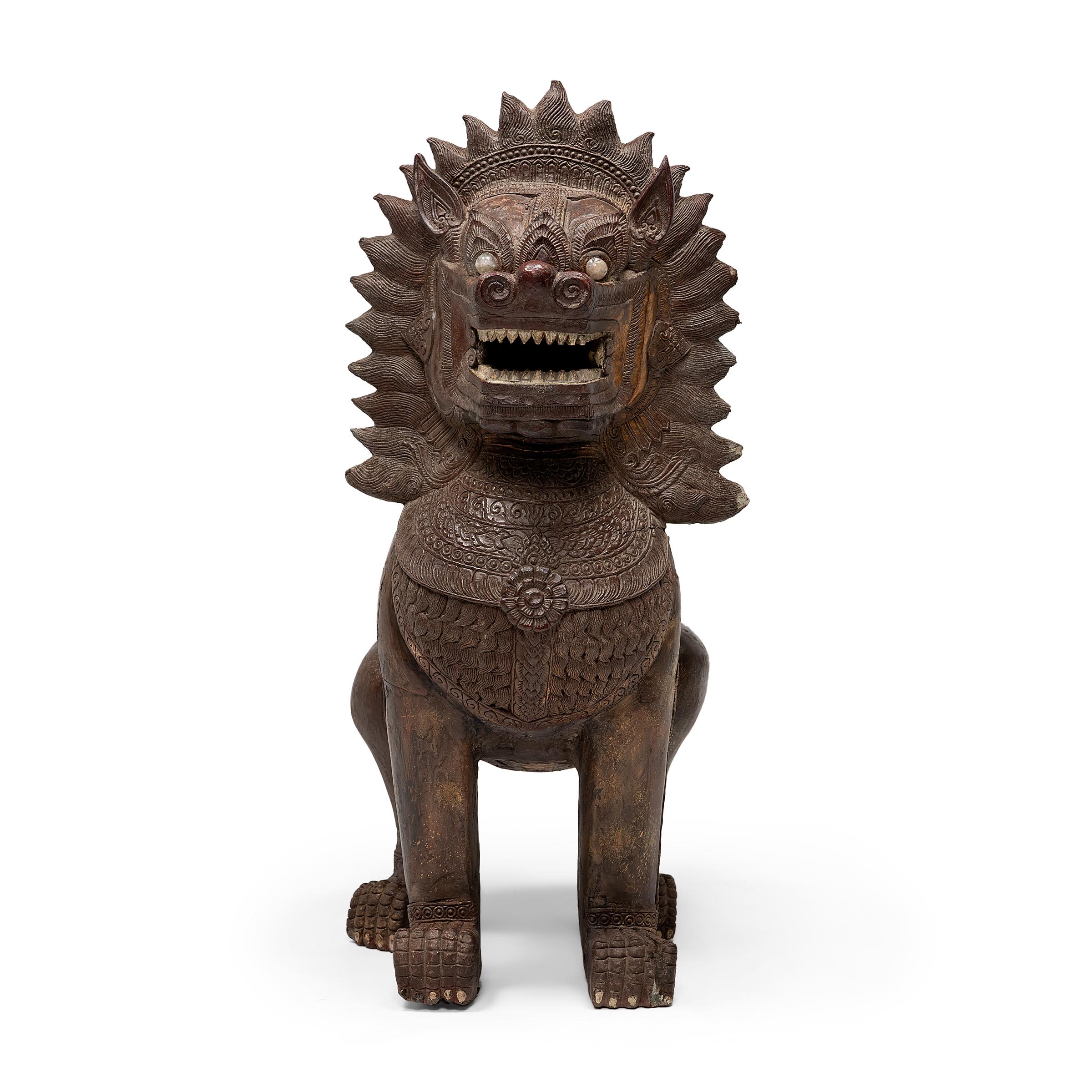 Grand and imposing, these monumental lion sculptures offer protection to all those who stand before them. Dated to the mid-19th century, the majestic pair is sculpted of carved wood and molded plaster with a gilt and polychrome finish, with