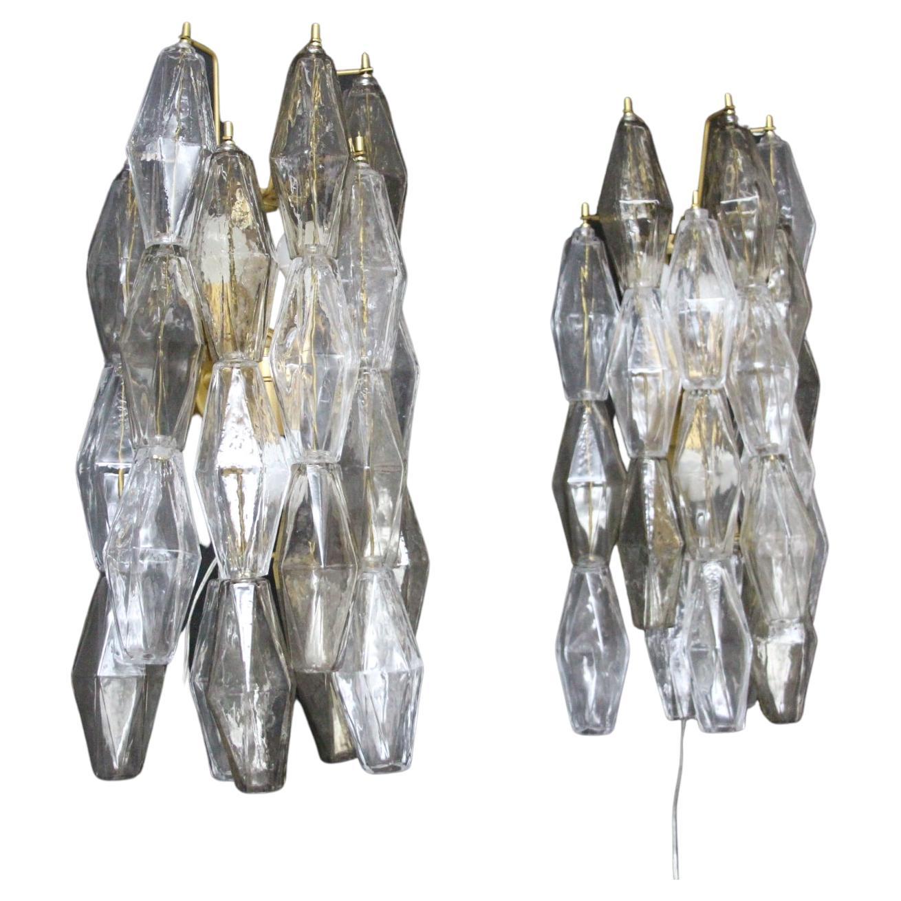 Beautiful pair of polyhedron sconces in clear and smoked textured blown glass.
Each piece of glass features diamonds shape with faceted sides and are hanged on 6 arms.They were individually made by hand in Murano.
Smoked pieces of glass change