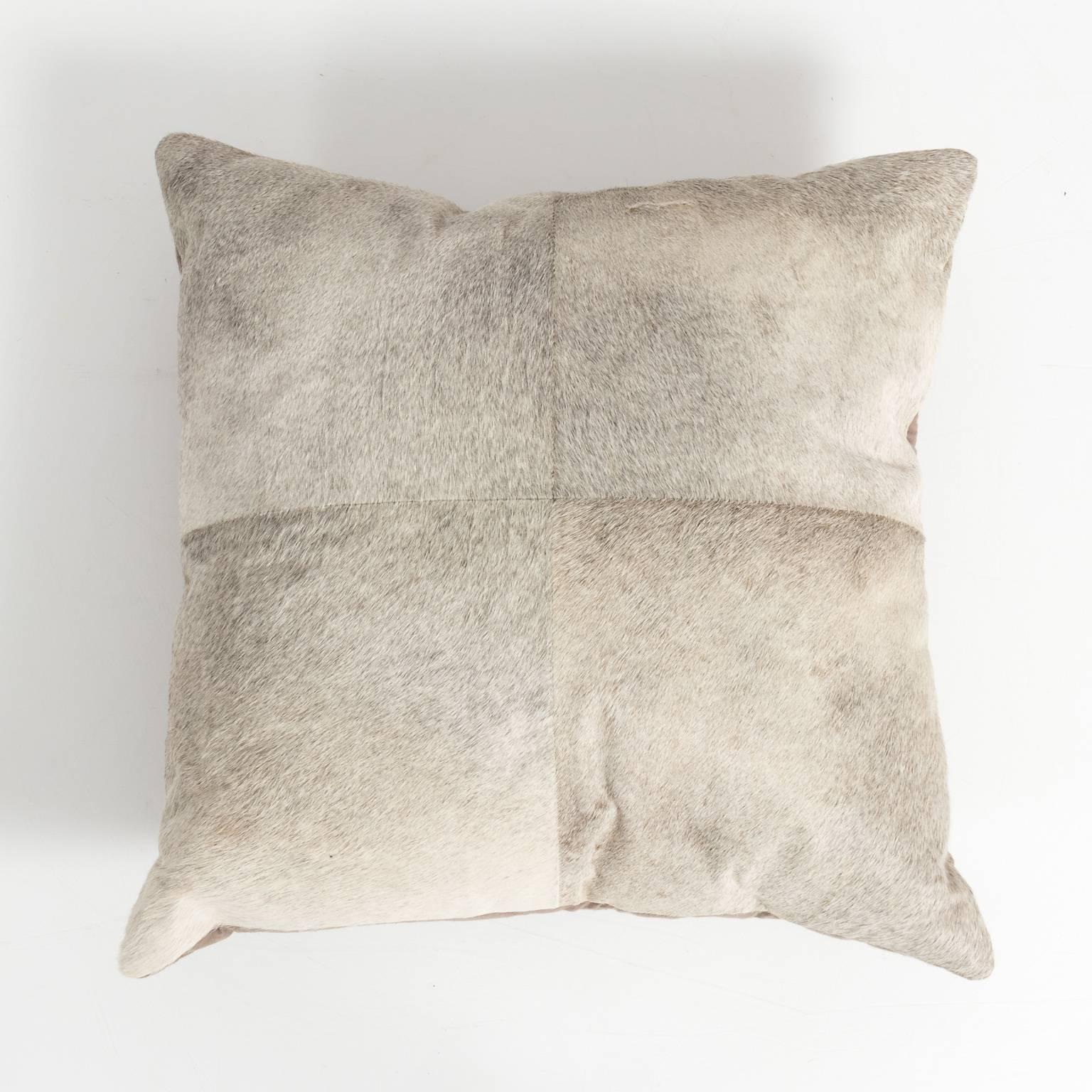 Pair of pony hair pillows in shades of gray, with feather and down inserts.
 