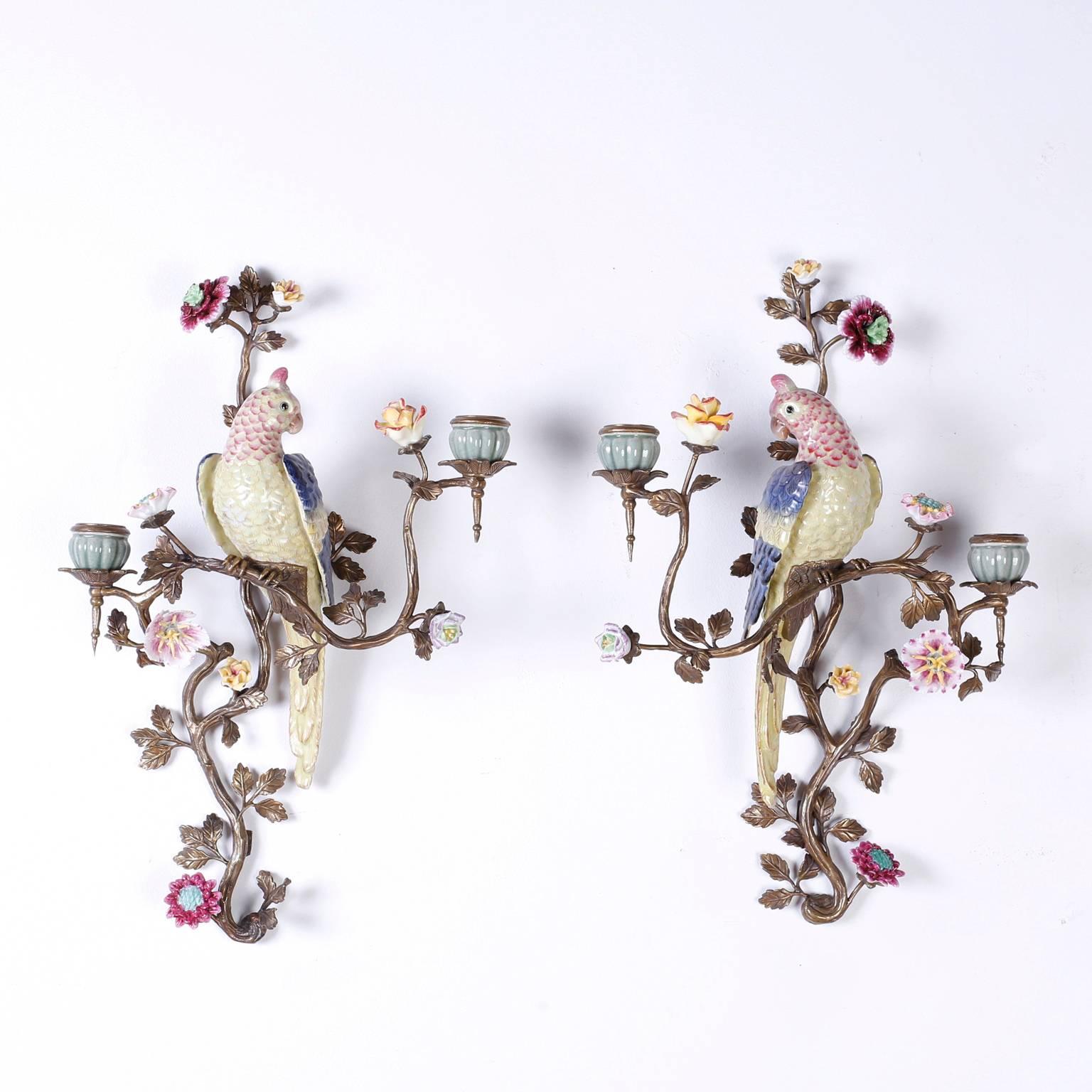 Fanciful pair of vintage sconces with porcelain birds or parrots and featuring delicate porcelain flowers set on brass stems with leaves having two candleholders on each sconce.