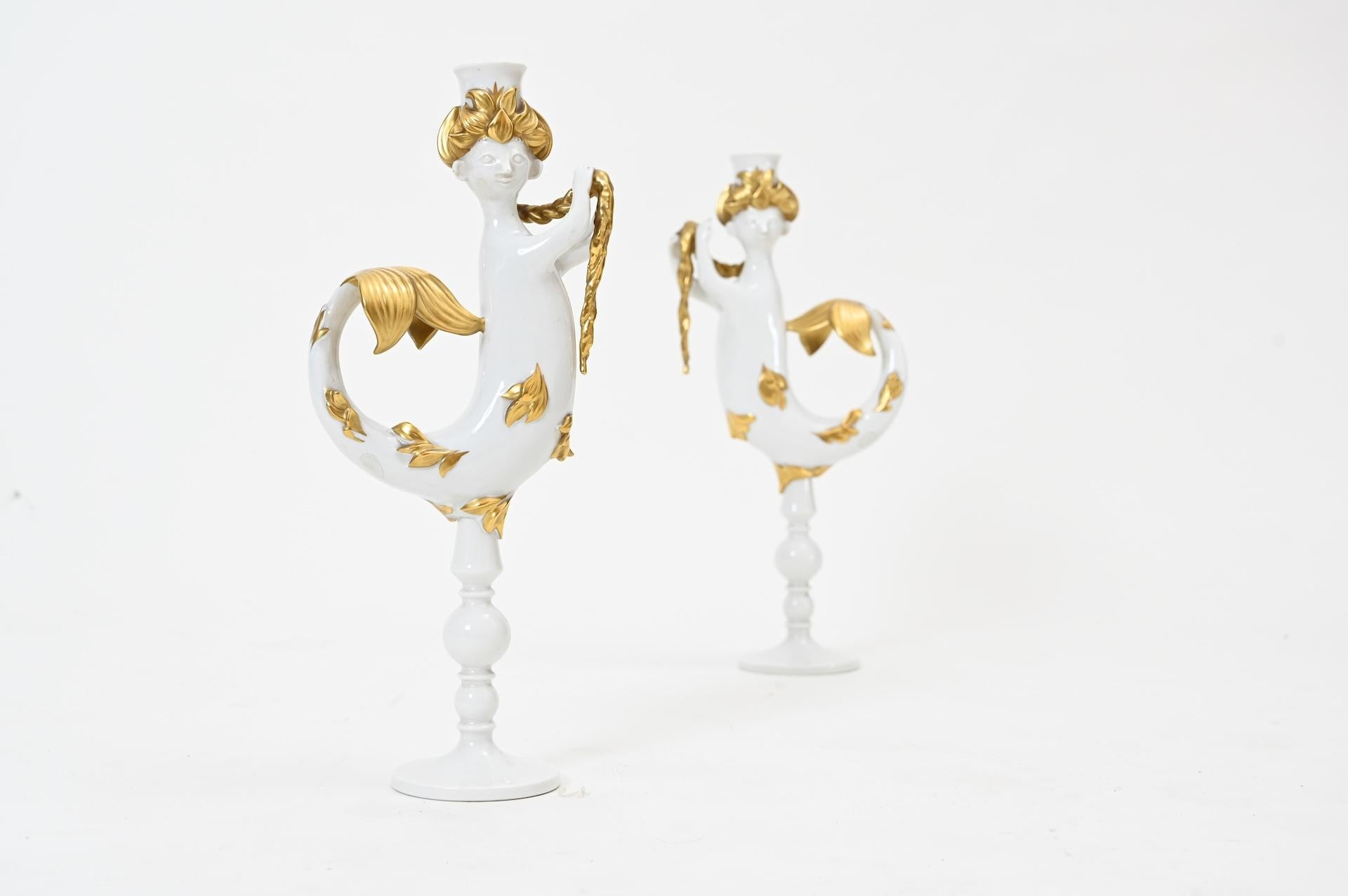 A pair of mermaid candlesticks by Bjorn Wiinblad, white and gold.