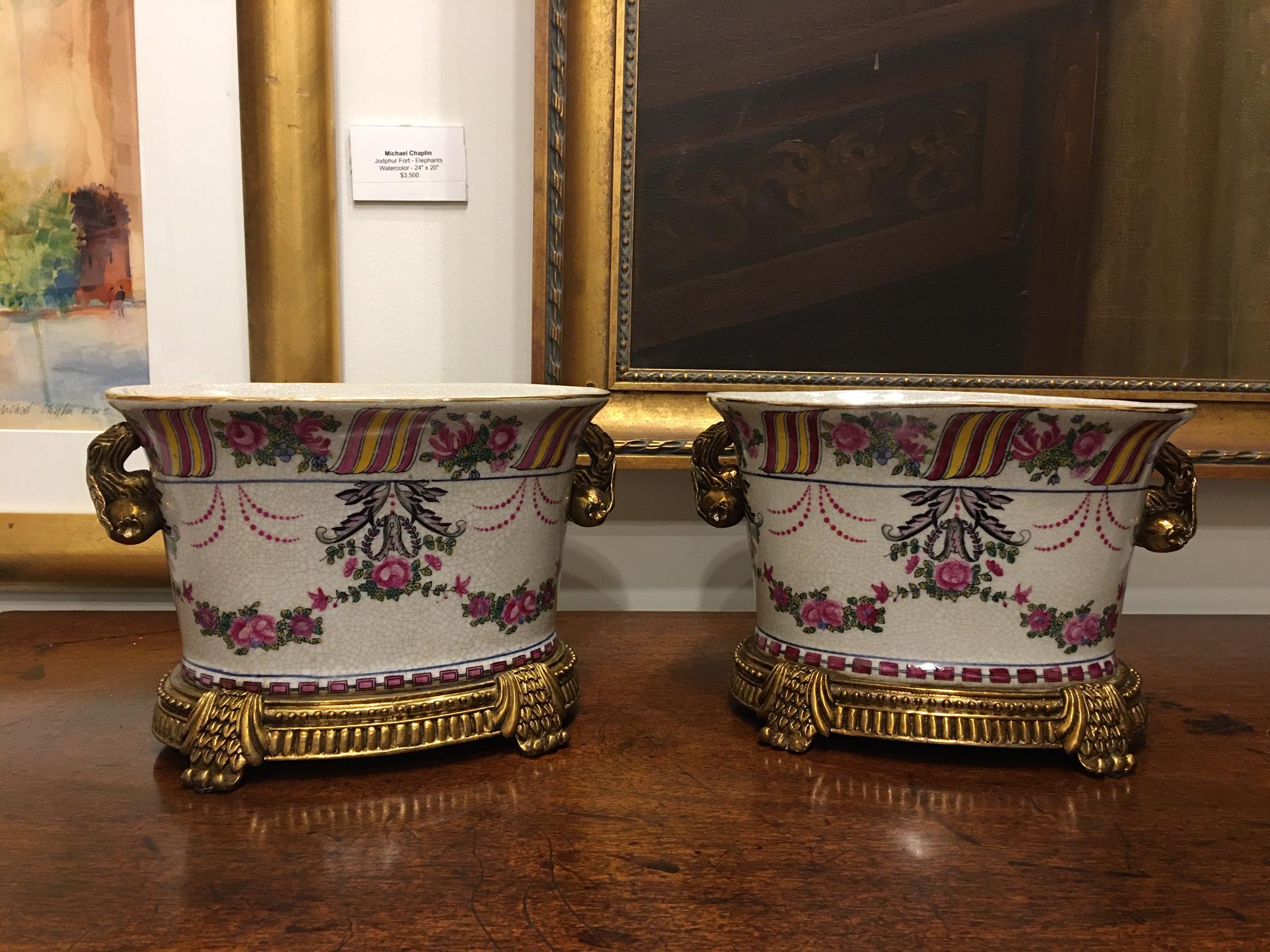 Pair of porcelain cache pots or jardinières with a floral motif, 20th century.