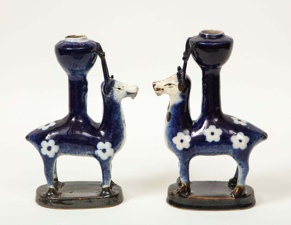 In blue enamel with white flowers; on oval plinth bases.