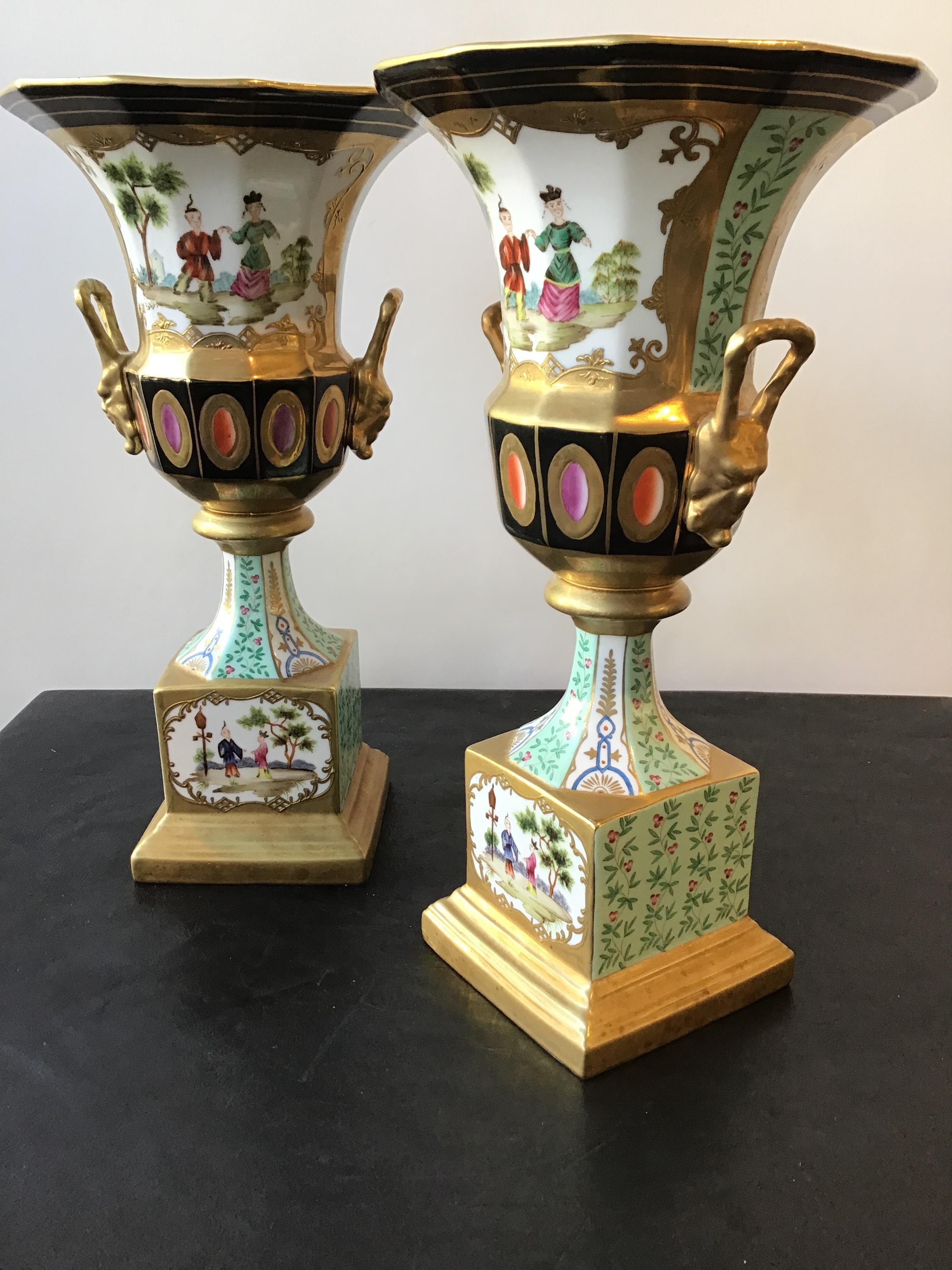 Pair of hand painted porcelain chinoiserie urns with gilt accents by Chelsea House.
