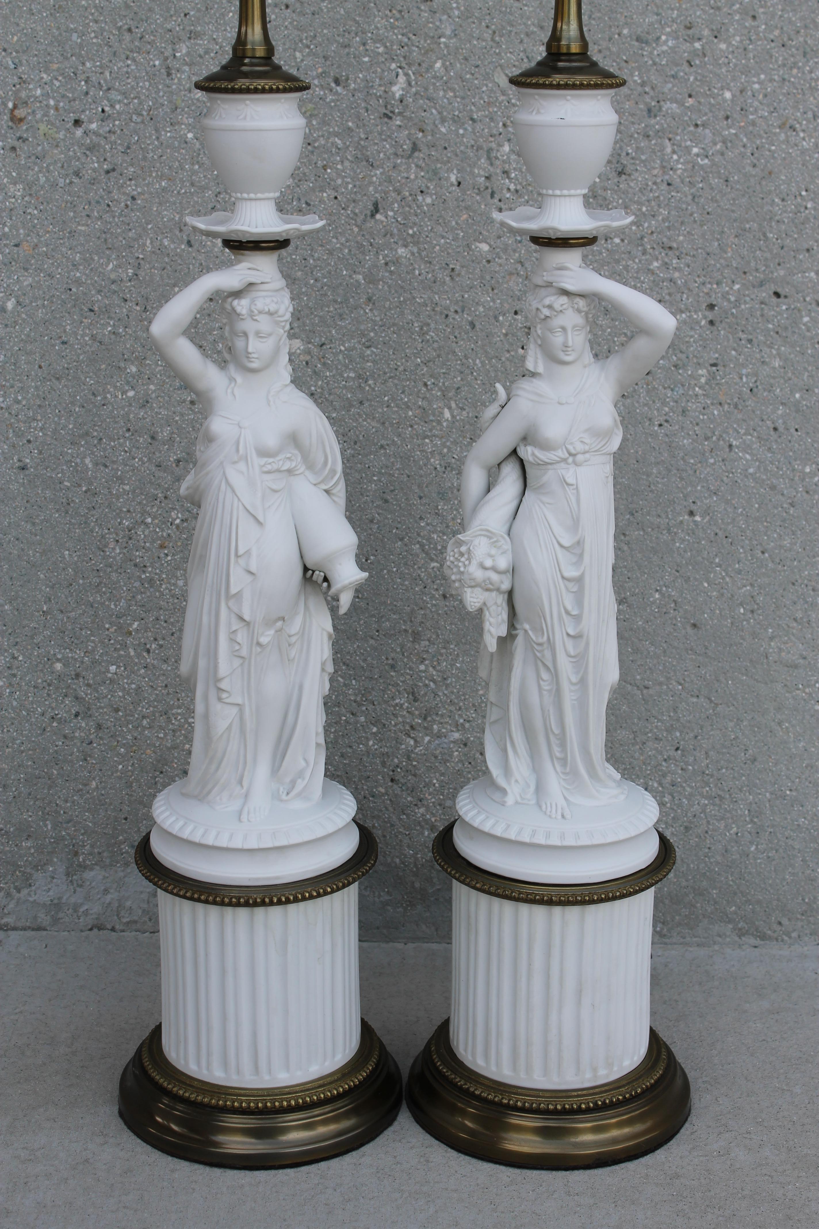 Pair of porcelain or Parian ware (is a type of biscuit porcelain imitating marble) Greek goddess lamps. One is Demeter, the goddess holding a cornucopia and the other is Iris, holding a jug of water. Demeter, the Greek goddess of Agriculture was