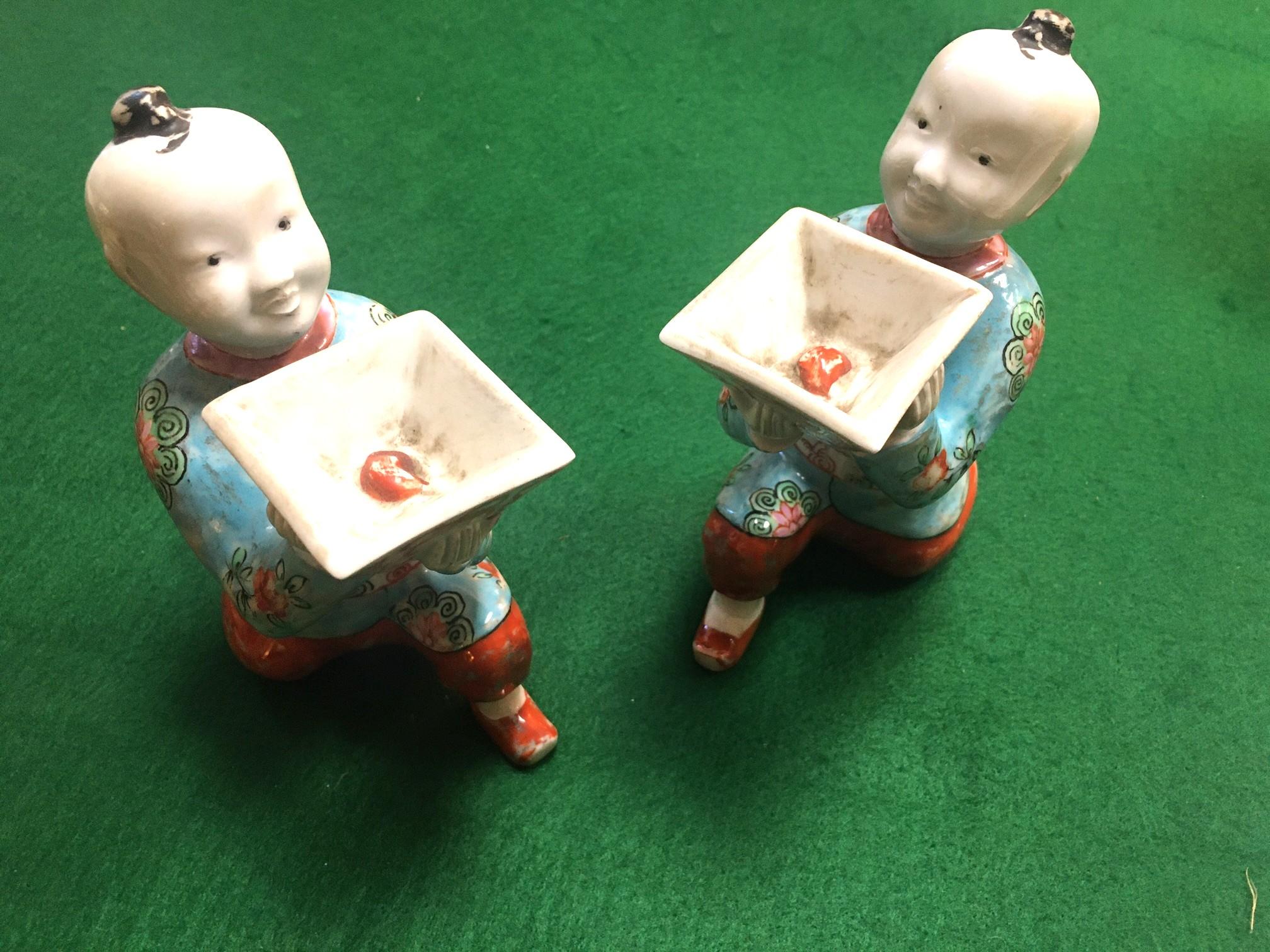 Chinese Export Pair of Porcelain Kneeling Chinese Boys Holding Shallow Single Blossom Vessels For Sale