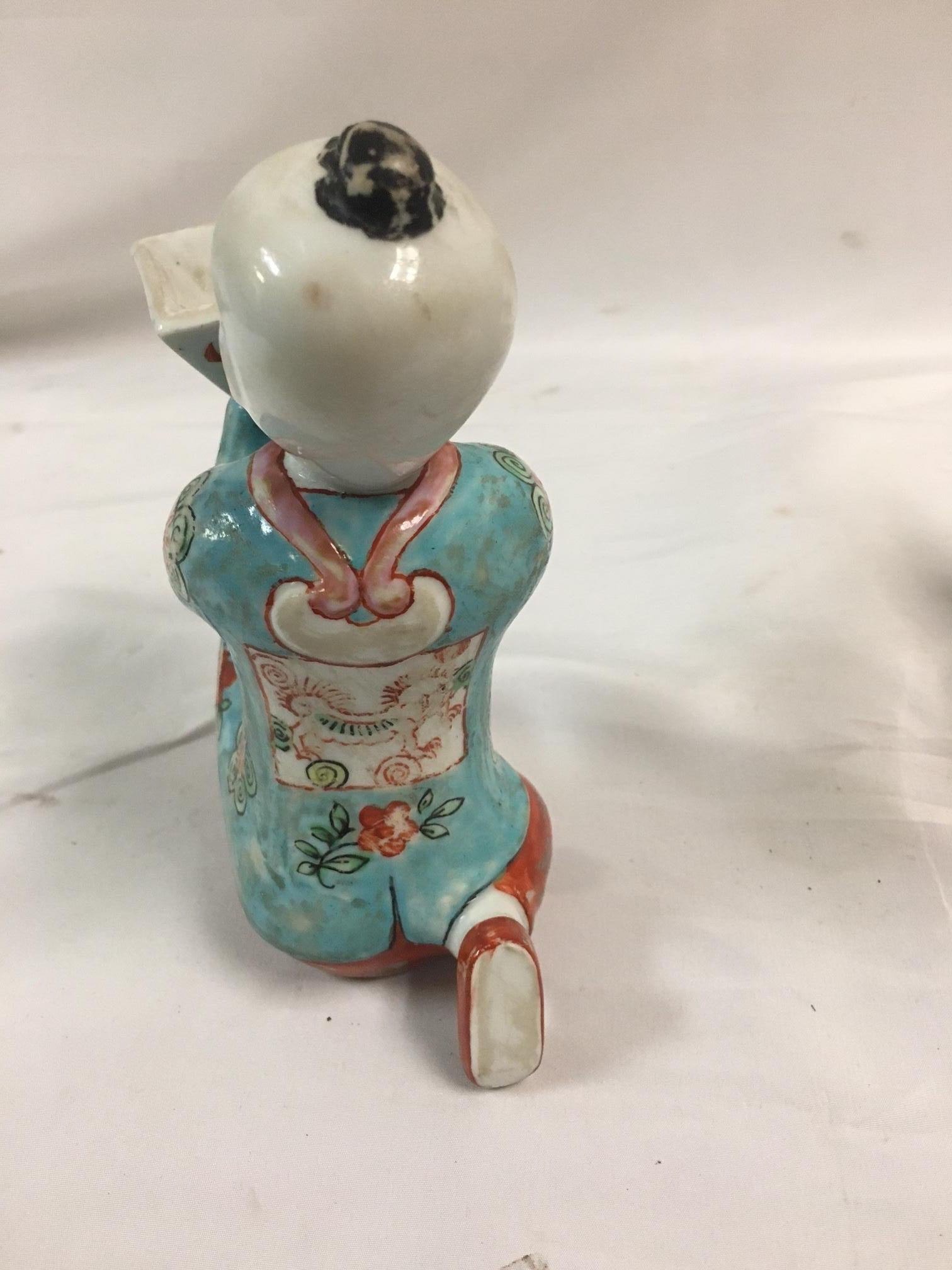 Late 19th Century Pair of Porcelain Kneeling Chinese Boys Holding Shallow Single Blossom Vessels For Sale