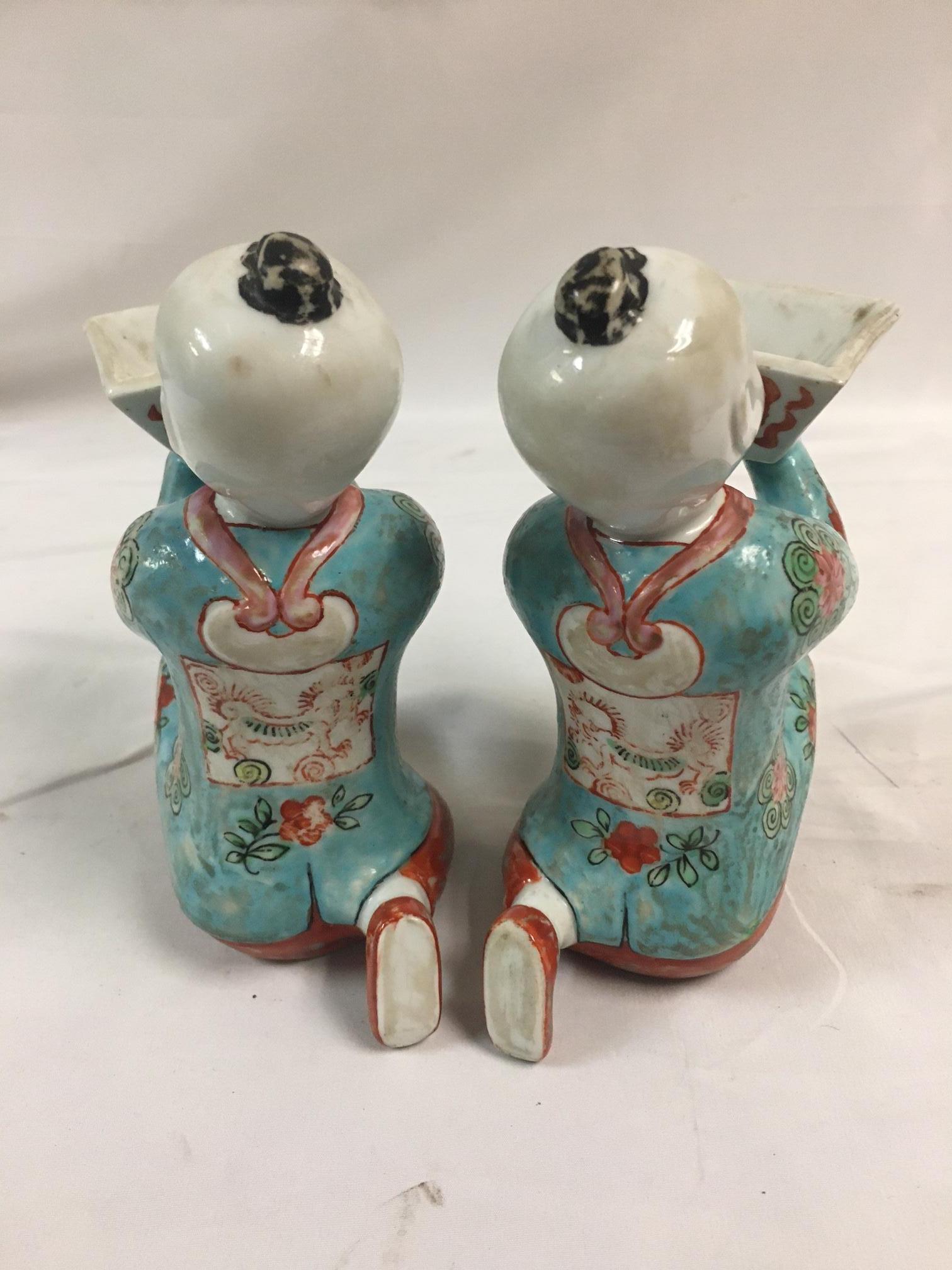 Pair of Porcelain Kneeling Chinese Boys Holding Shallow Single Blossom Vessels For Sale 1