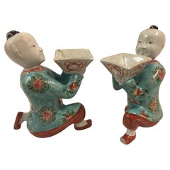 Pair of Porcelain Kneeling Chinese Boys Holding Shallow Single Blossom Vessels