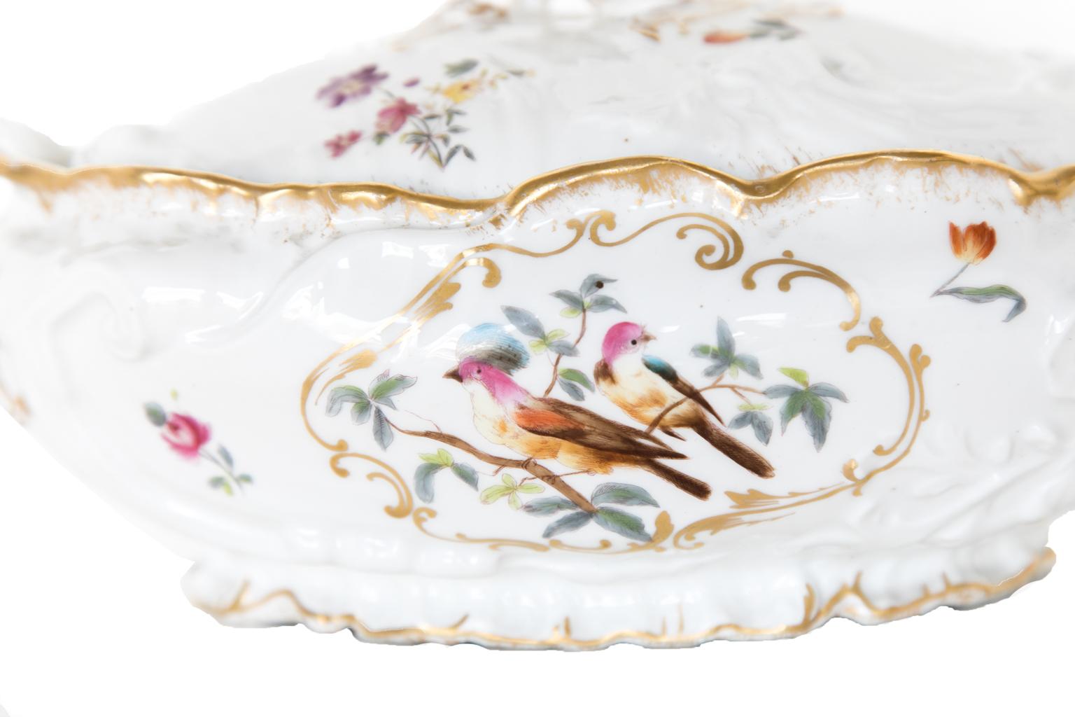 Pair of porcelain Limoges tureens, with the body of each tureen molded in high relief with floral and bird designs trimmed in gold. Each is marked: Patented November 11, 1890. (Will take picture of the bottom and send).