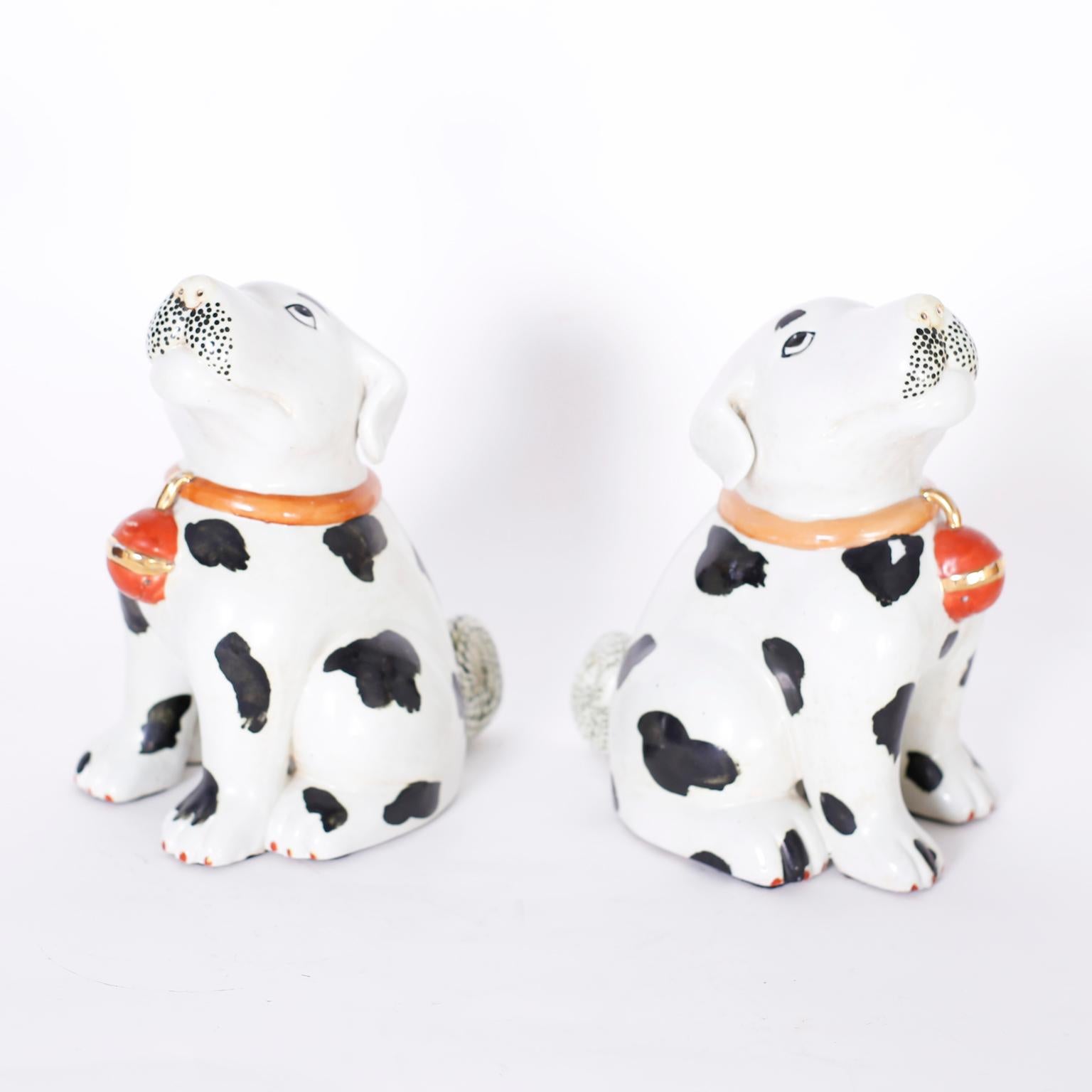 Pair of Chinese porcelain puppies or Dalmatians with collars and bells, striking a familiar puppy pose. Signed with chop marks on the bottom.