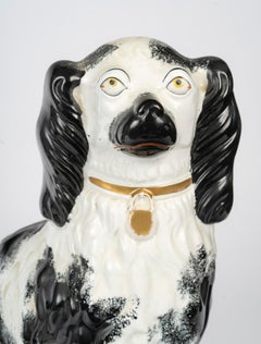 Pair of Porcelain Sculpture Depicting King Charles Spaniels, 20th Century.
