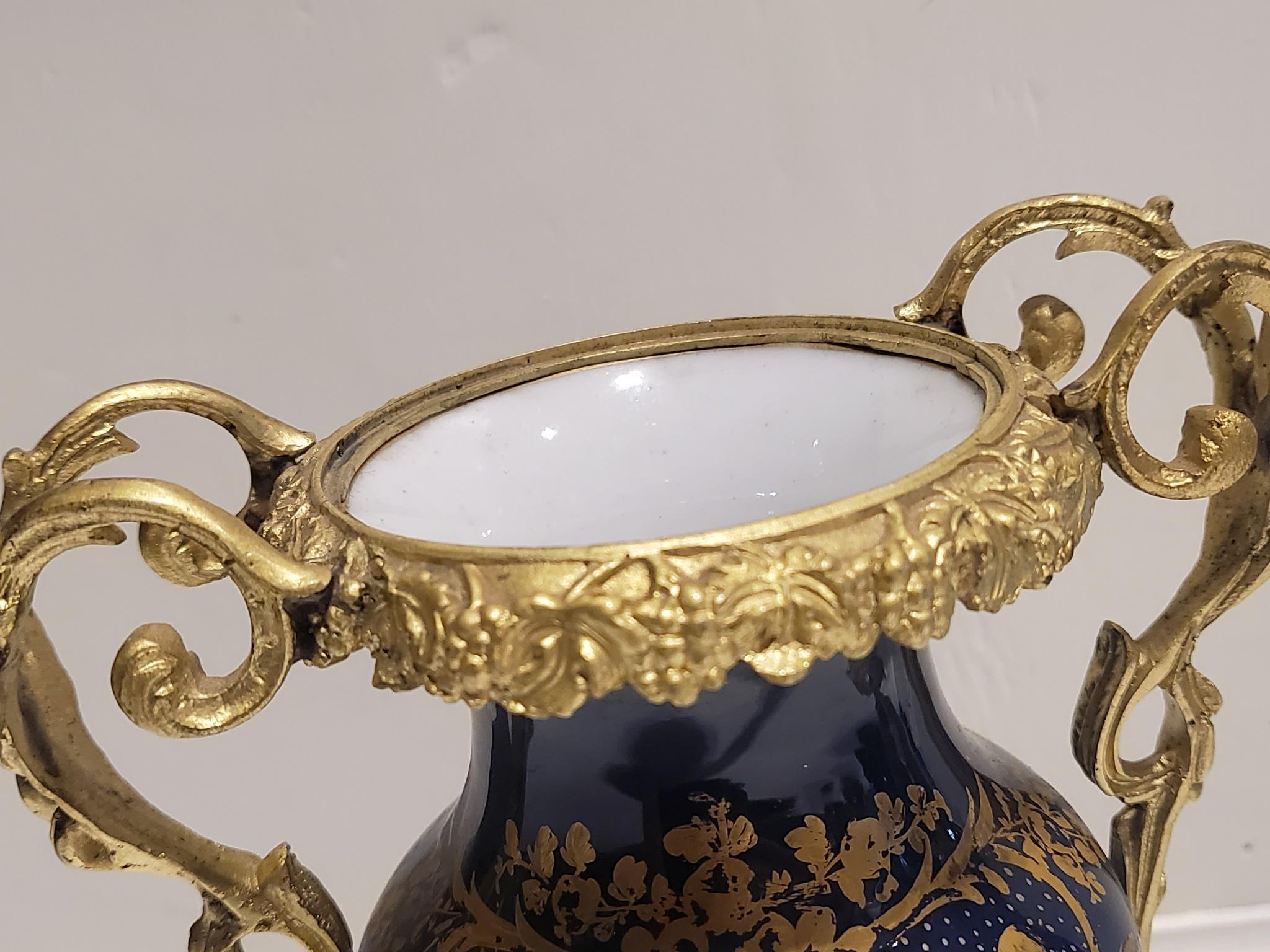 A pair of ormolu mounted serves porcelain vases.