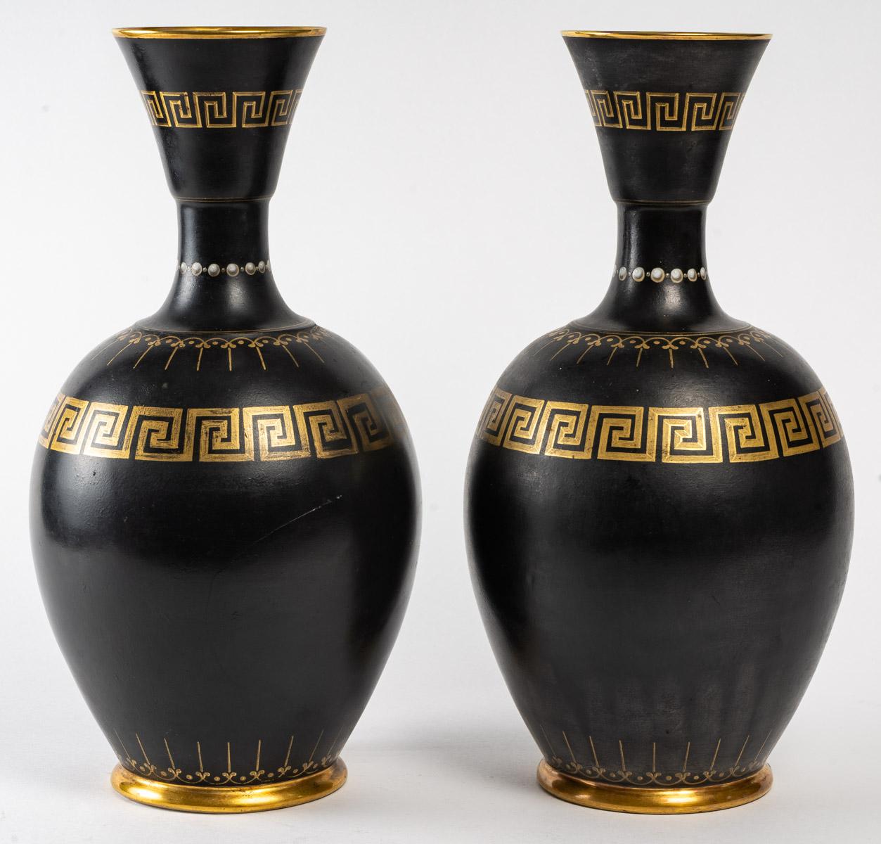 Pair of porcelain vases in the taste of ancient Greece, gilding decoration on black background, early 20th century.
Measures: H: 33.5 cm, D: 19 cm.
   