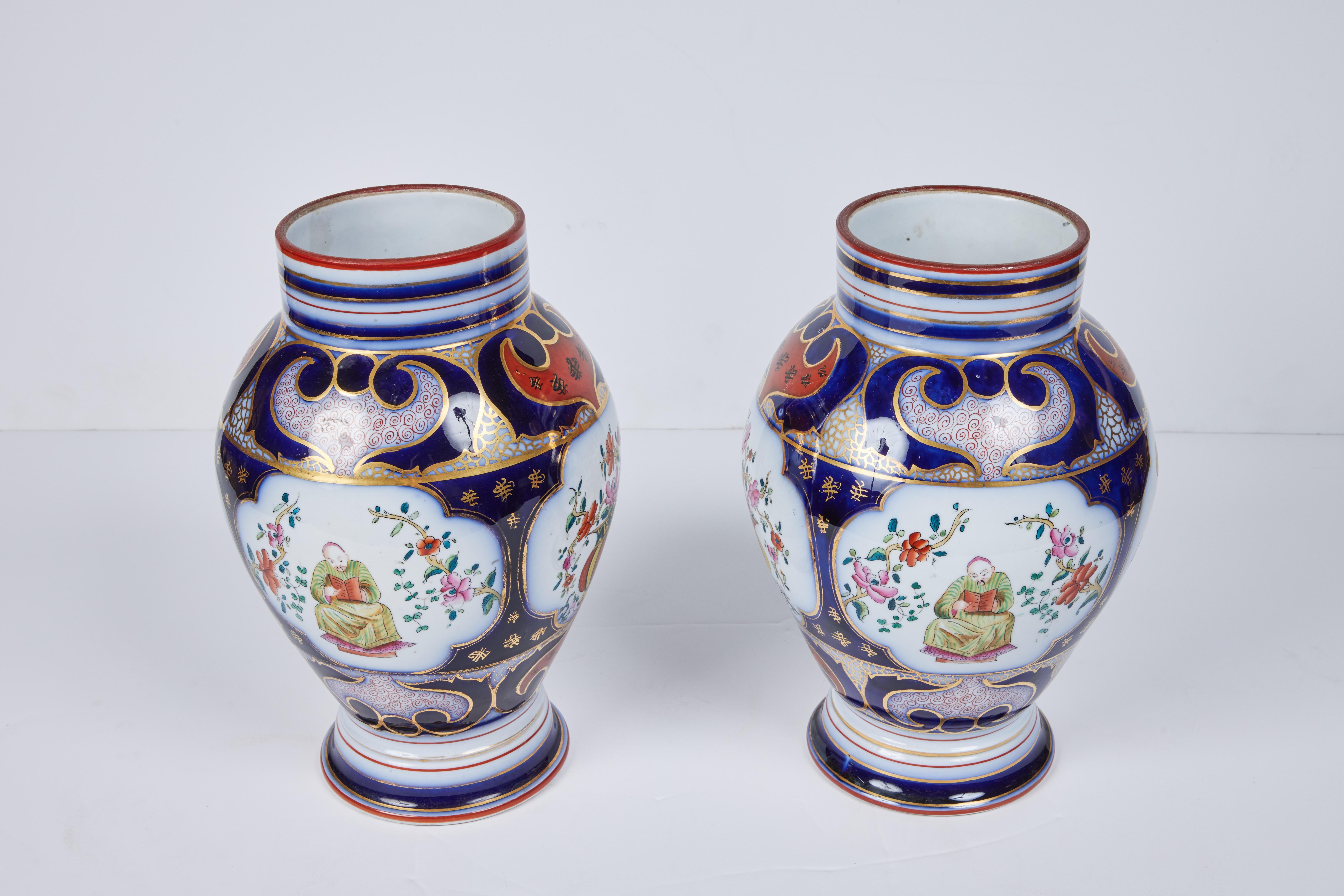 A beautiful pair of porcelain vases with a hand painted and gilded glazed overlay.