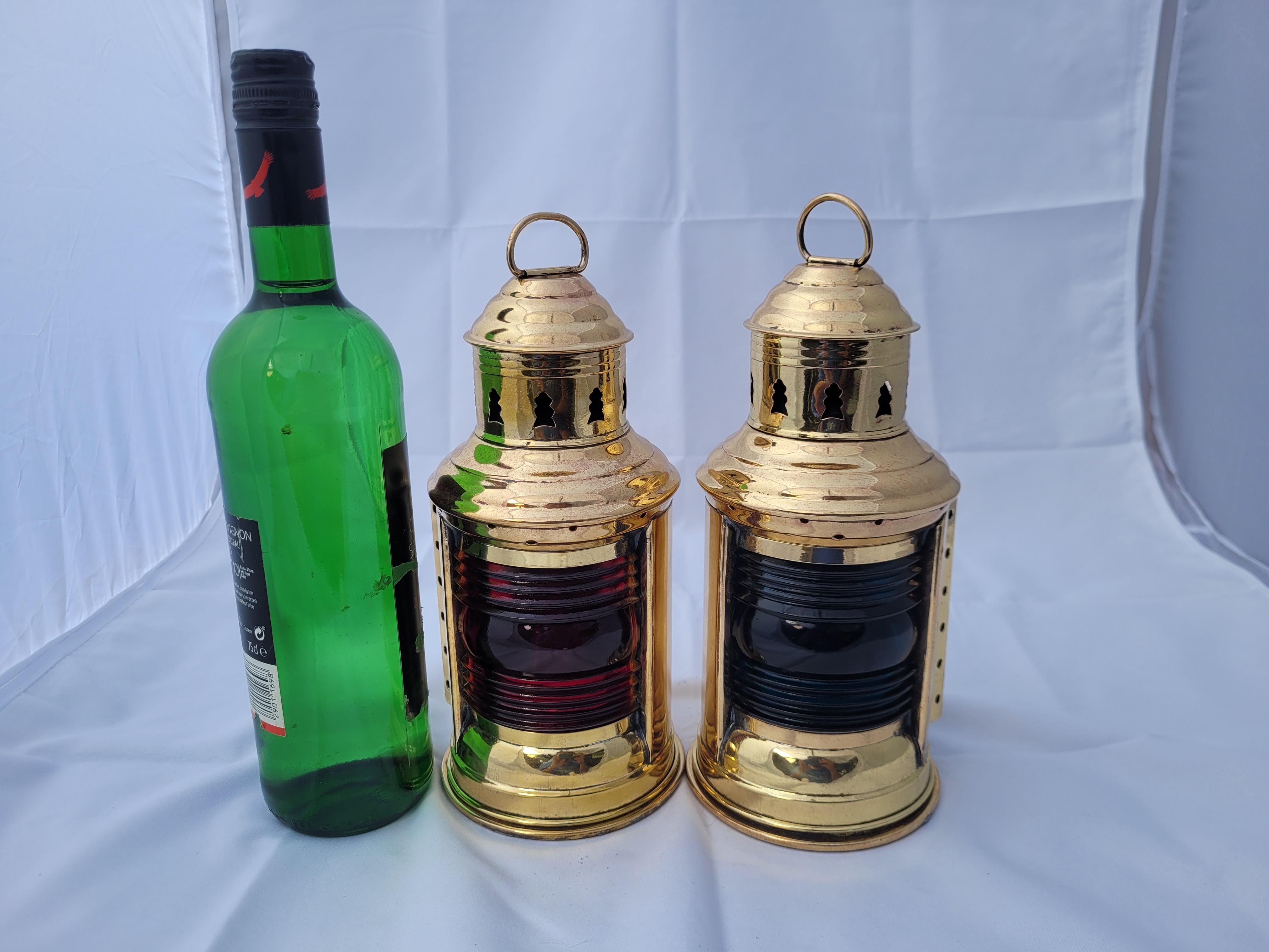 Pair of Brass yacht lanterns with highly polished and lacquered finish. Vented tops with carry rings. Oil Burners inside. With red and blue Fresnel Lenses, manufactured by Perkins.

Weight: 2 lbs.
Overall Dimensions: 10
