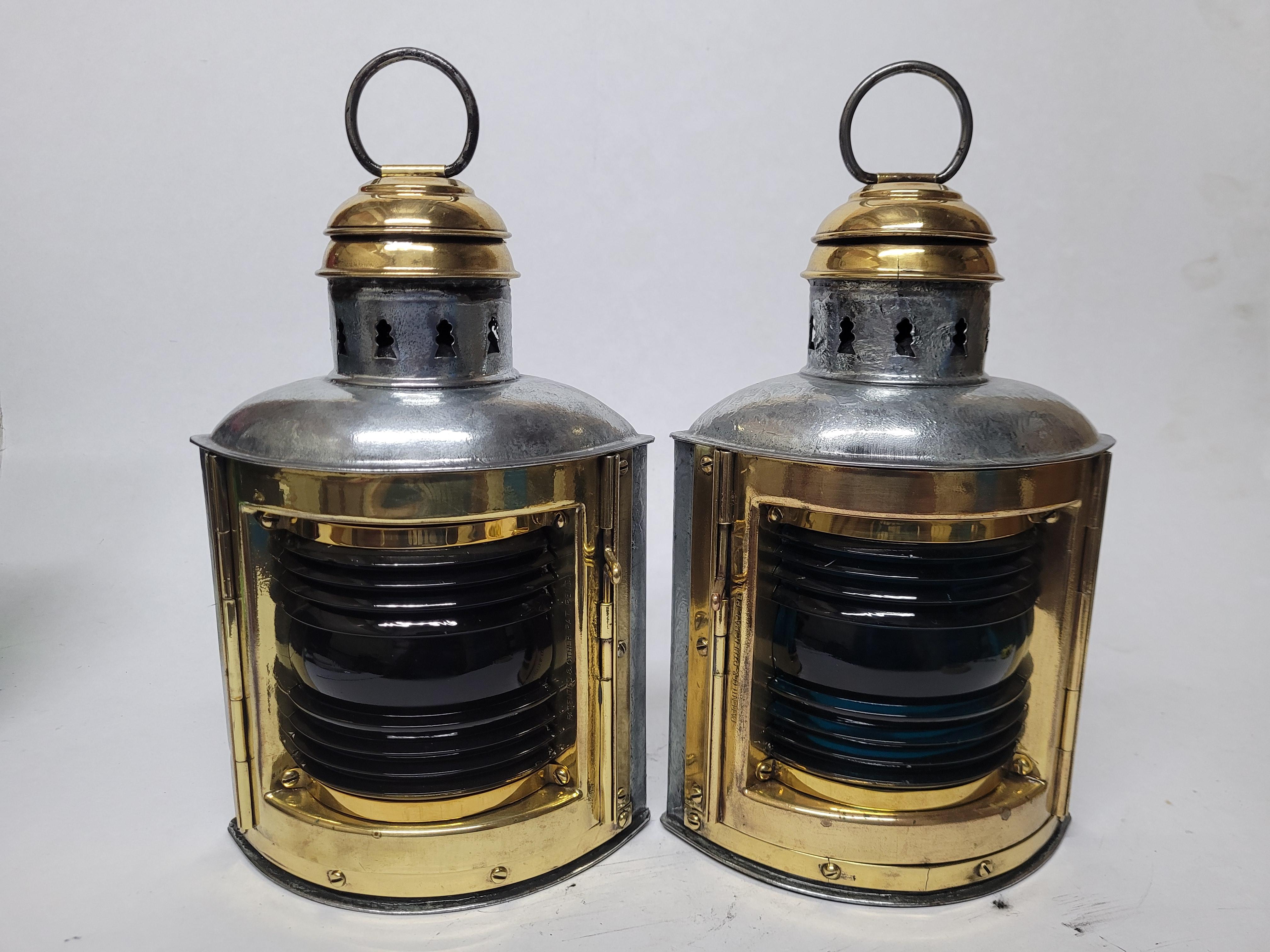 Polished steel port and starboard boat lanterns with blue and red fresnel lenses. The lenses are fitted to polished and lacquered brass frames. With makers badge from Perko. American Circa 1955.

Weight: 2.55 lbs.
Overall Dimensions: 11
