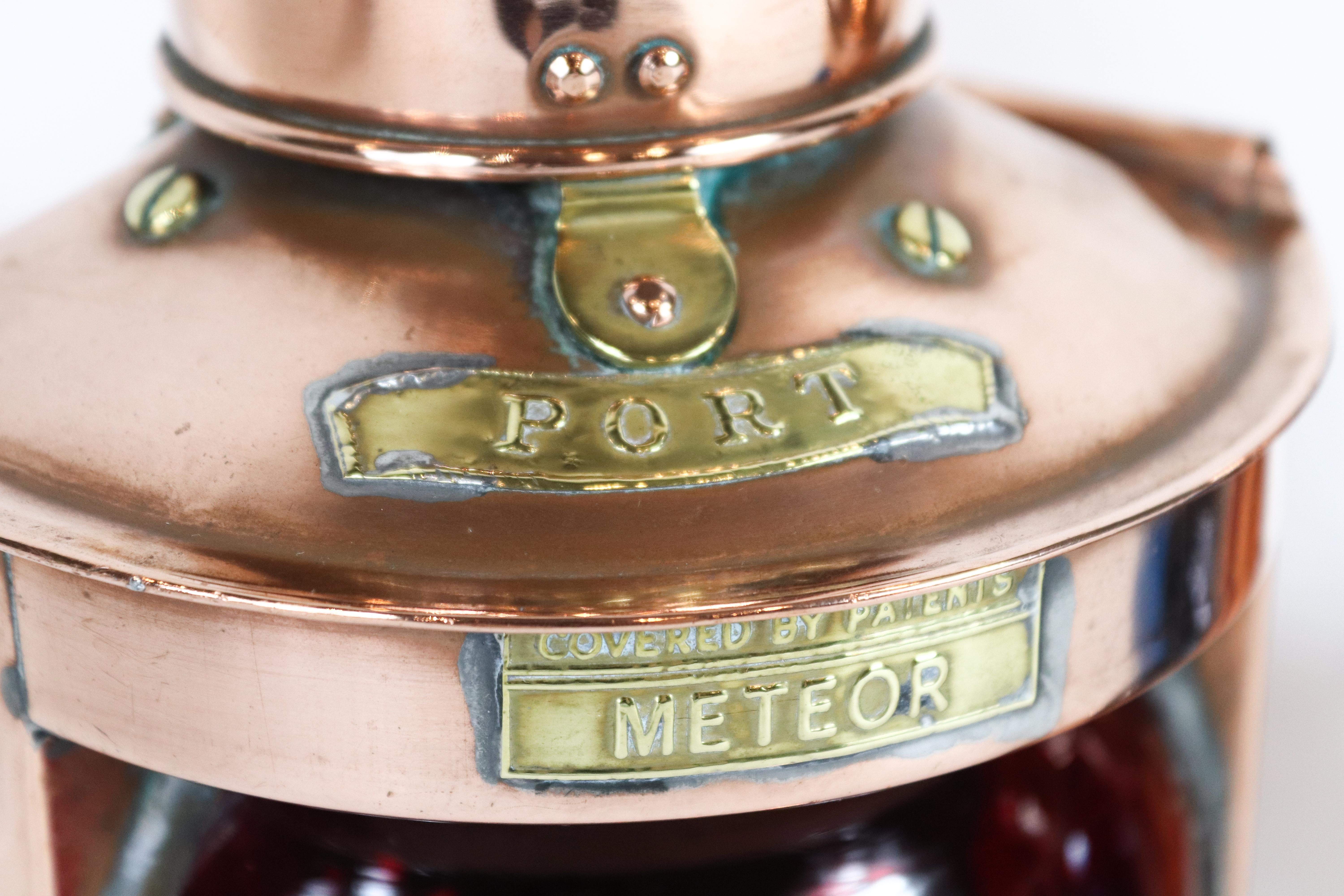 Copper port and starboard lanterns by Meteor. Red and blue globe lenses with brass badges and carry handles. Measures: 10 1/2