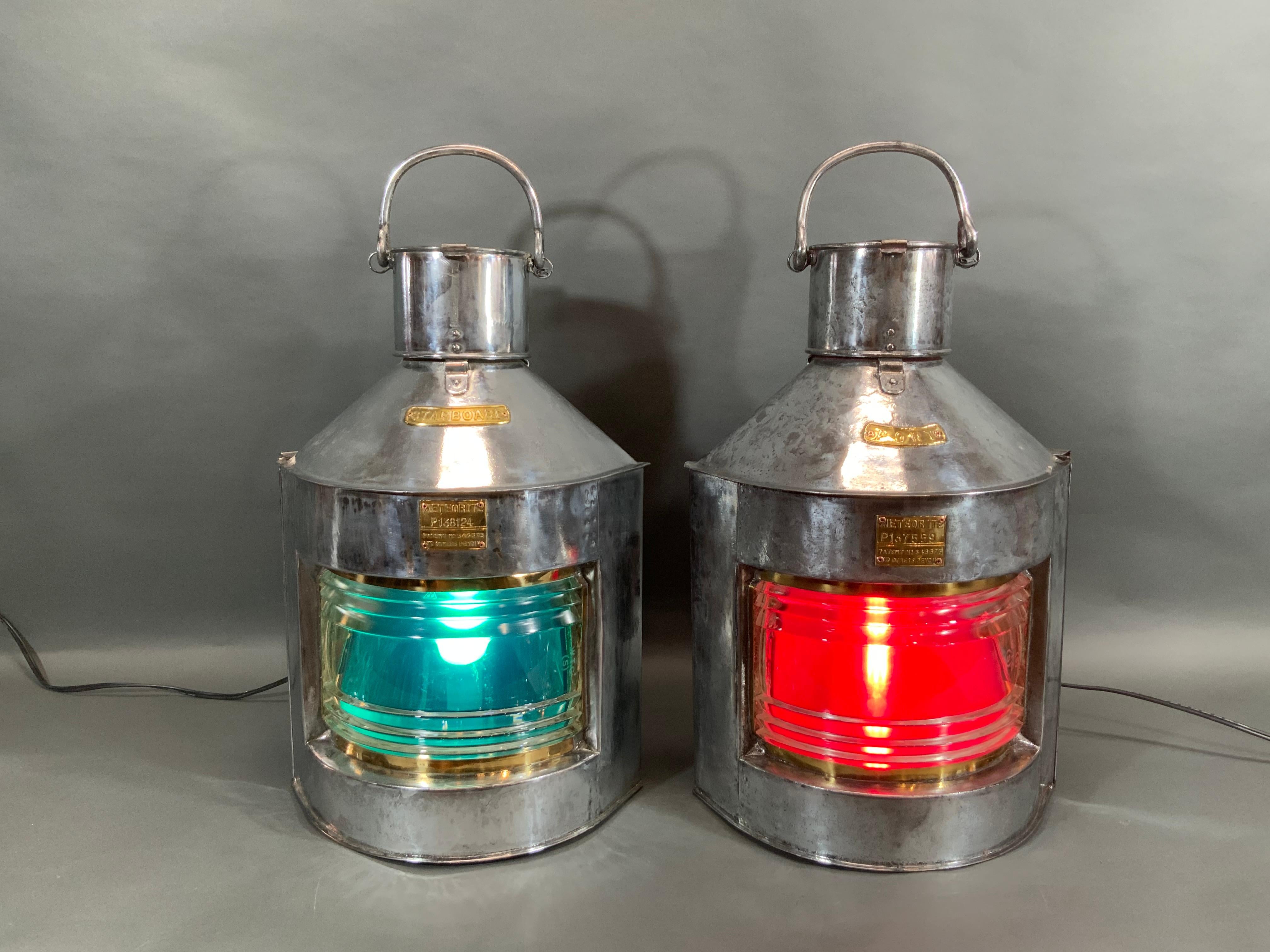 Ship's port and starboard lanterns with polished and lacquered steel cases, glass Fresnel lenses, red and green filters, electric sockets, etc.. With brass maker's badges and serial numbers from 