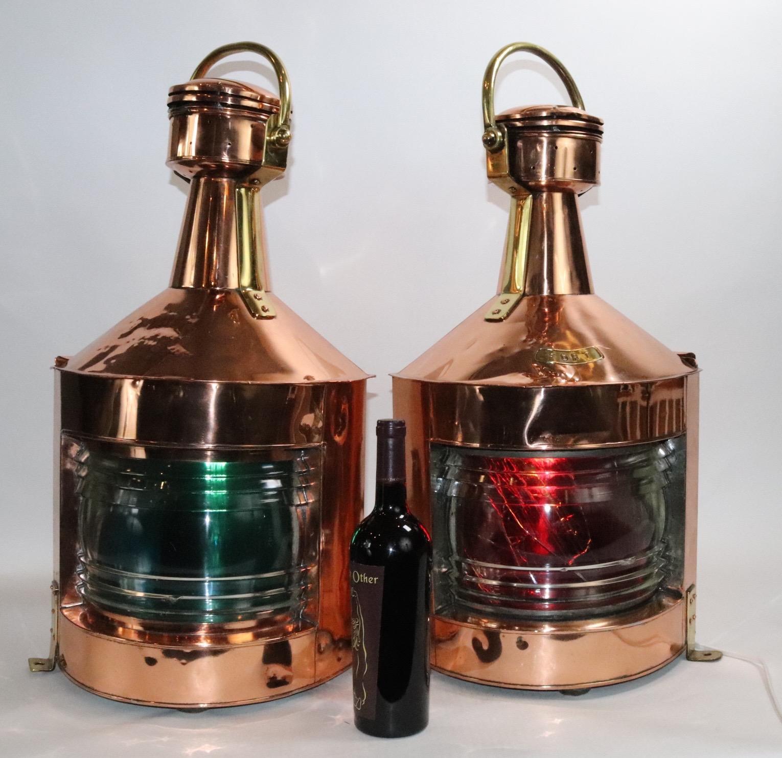 Giant pair of port and starboard ships lanterns by an English maker. With clear Fresnel lenses and colored filters. The red filter is cracked. This is a very large and substantial pair of ships lights. These old relics do have some dents and old