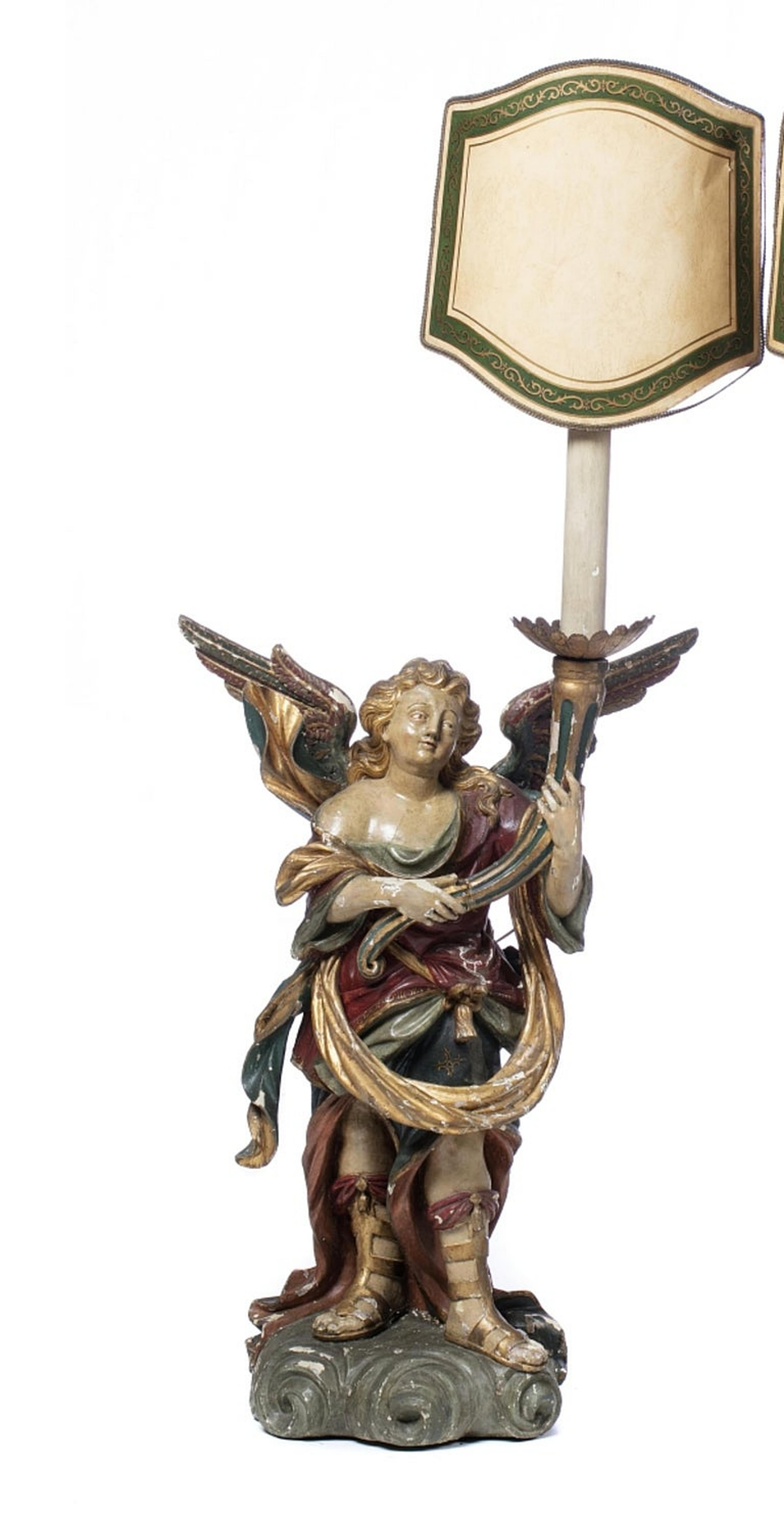 Pair of Portuguese Candeliary Seraphins

19th century 
in polychrome and gilded wood. 
The figures are represented standing, holding cornucopias. 
Adapted to lamps. 
Little defects in polychromy. 
Measure: Height: (sculpture) 90 cm.
Good condition.