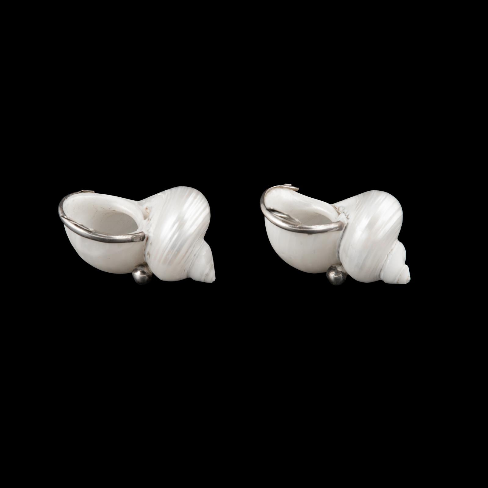 Pair of Portuguese Nautical Silver-Mounted Shell Salt Cellars with Spoons

Origin: Portugal, Lisbon
Date: Circa 1985–2000
Materials: Natural seashell, sterling silver (925/1000)
Hallmarks: Portuguese “Águia” (eagle) mark for Lisbon,