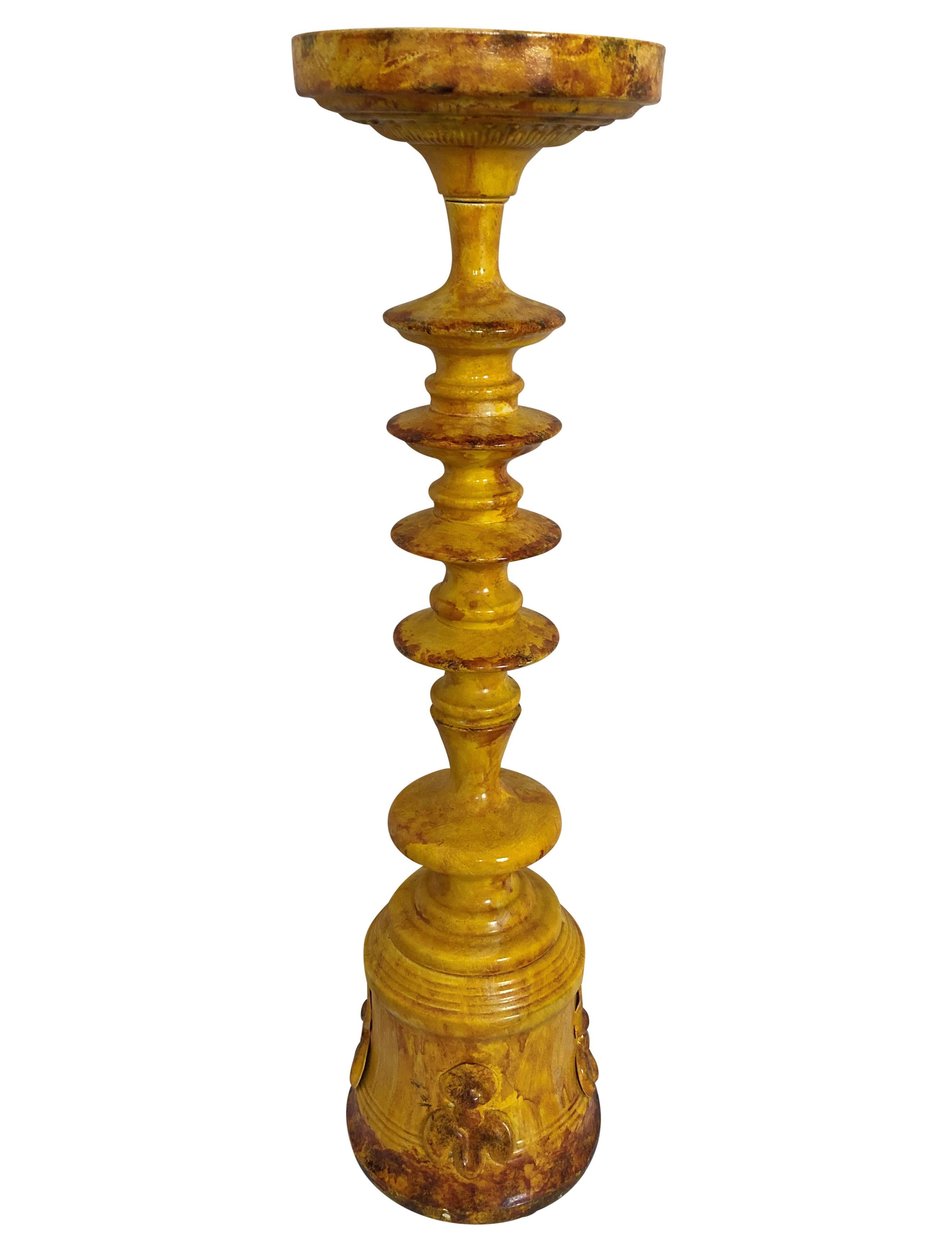 A pair of large Portuguese tole-ware candlesticks, hand painted in yellow and burnt Sienna.