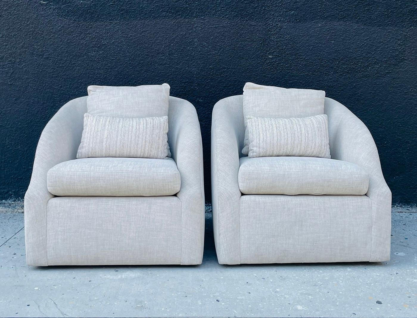 Add a touch of modern sophistication to your living space with this exquisite Pair of Post Modern Armchairs with a Swivel Base, crafted in the USA in the 1990's. These sleek and stylish chairs feature a unique design with a swivel base for added
