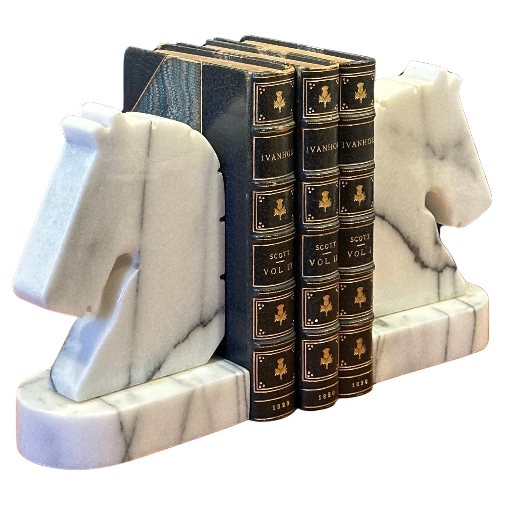 Gorgeous pair of post-modern white carrara marble horse head bookends, circa 1980s. The bookends are heavy, solid and well crafted. They measure 9.5