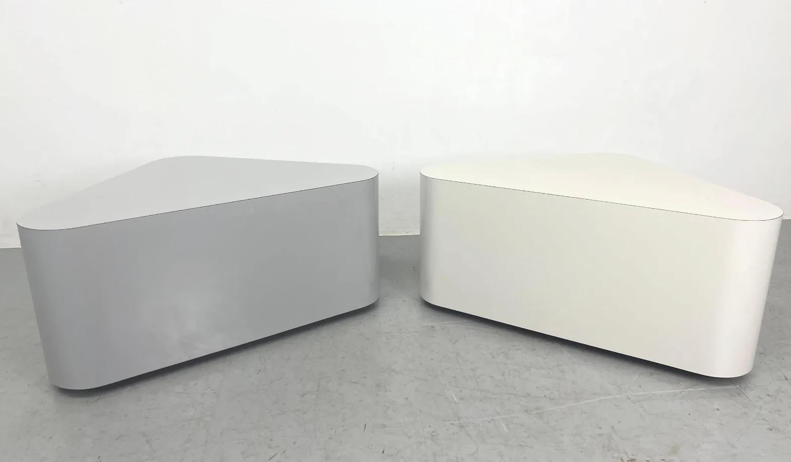 Pair of Post Modern Laminate rounded Triangular Side Tables. One is a darker Gray and others is light gray. Each of these end tables have casters to allow them to roll around. Made in USA Circa 1980. Located in Brooklyn NYC

Sold as a set of