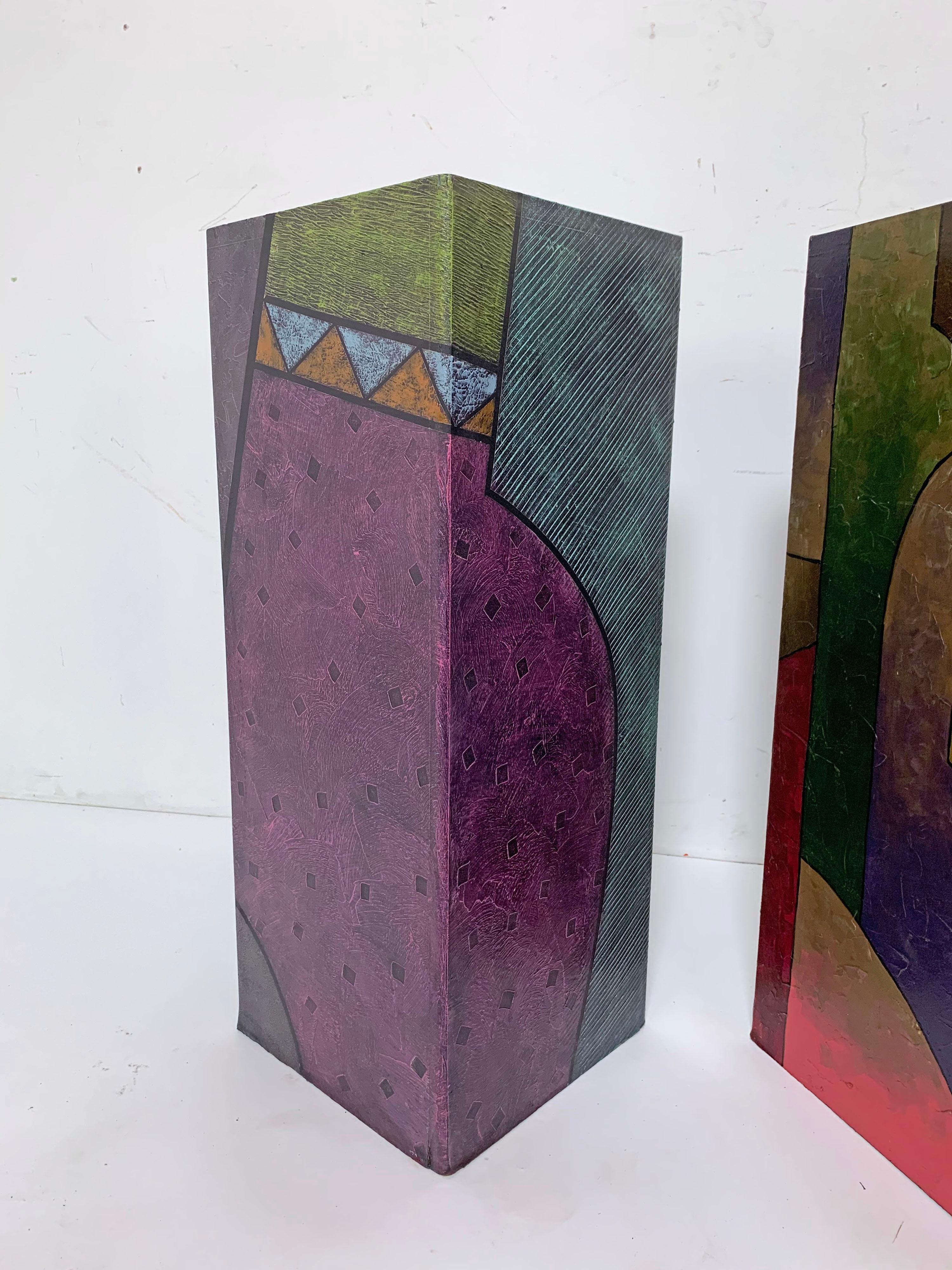 Pair of pedestals, hand painted in the influence of the Memphis Group, circa 1980s. Wonderful splash of abstract color and at the perfect height to serve as lamp stands or end tables.