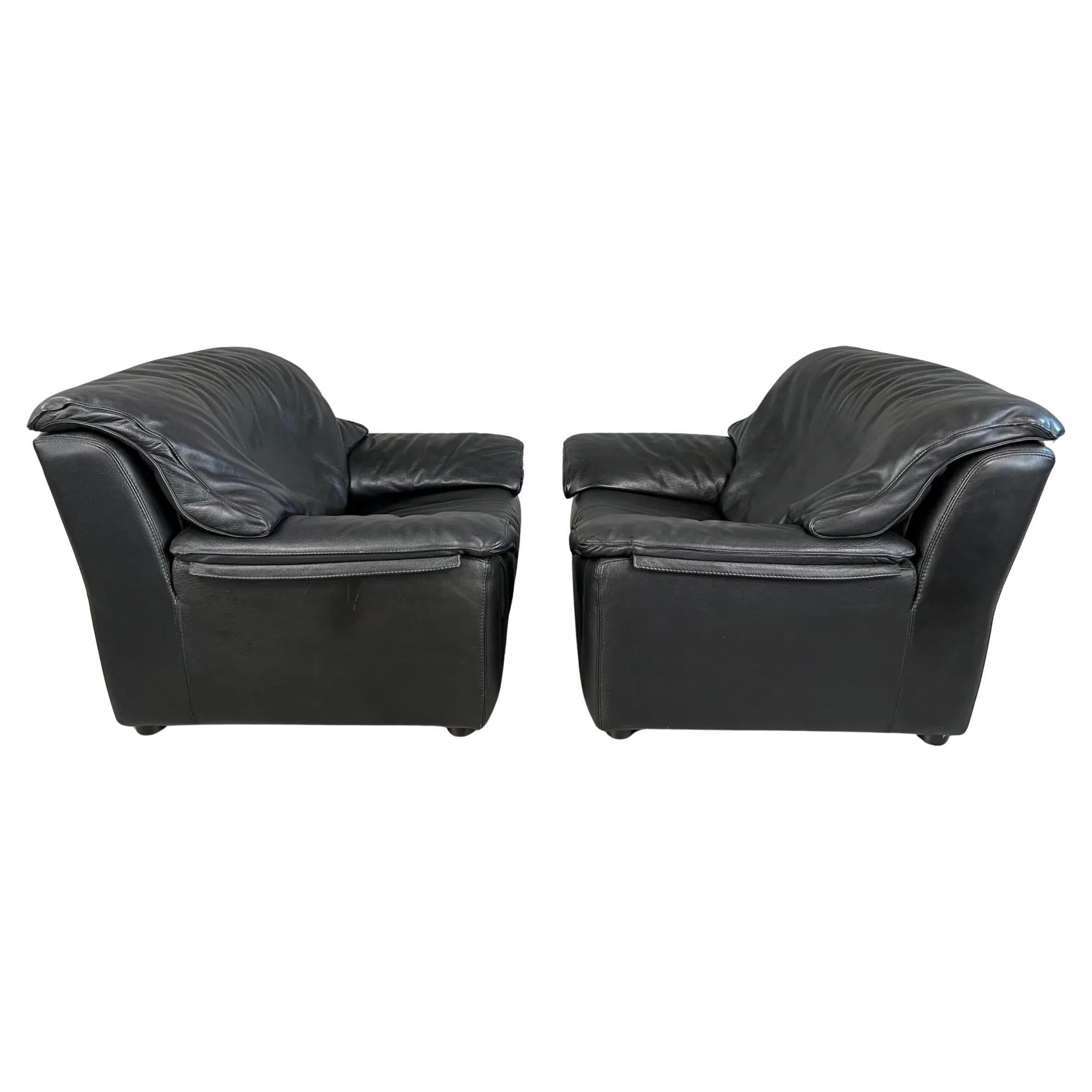 Pair of Italian Black Leather Lounge armchairs with removable cushions and armrests attached with zippers. High end soft leather upholstery - Pillow style post modern design. Made in Italy, Located in Brooklyn NYC.

Dimensions: D 33
