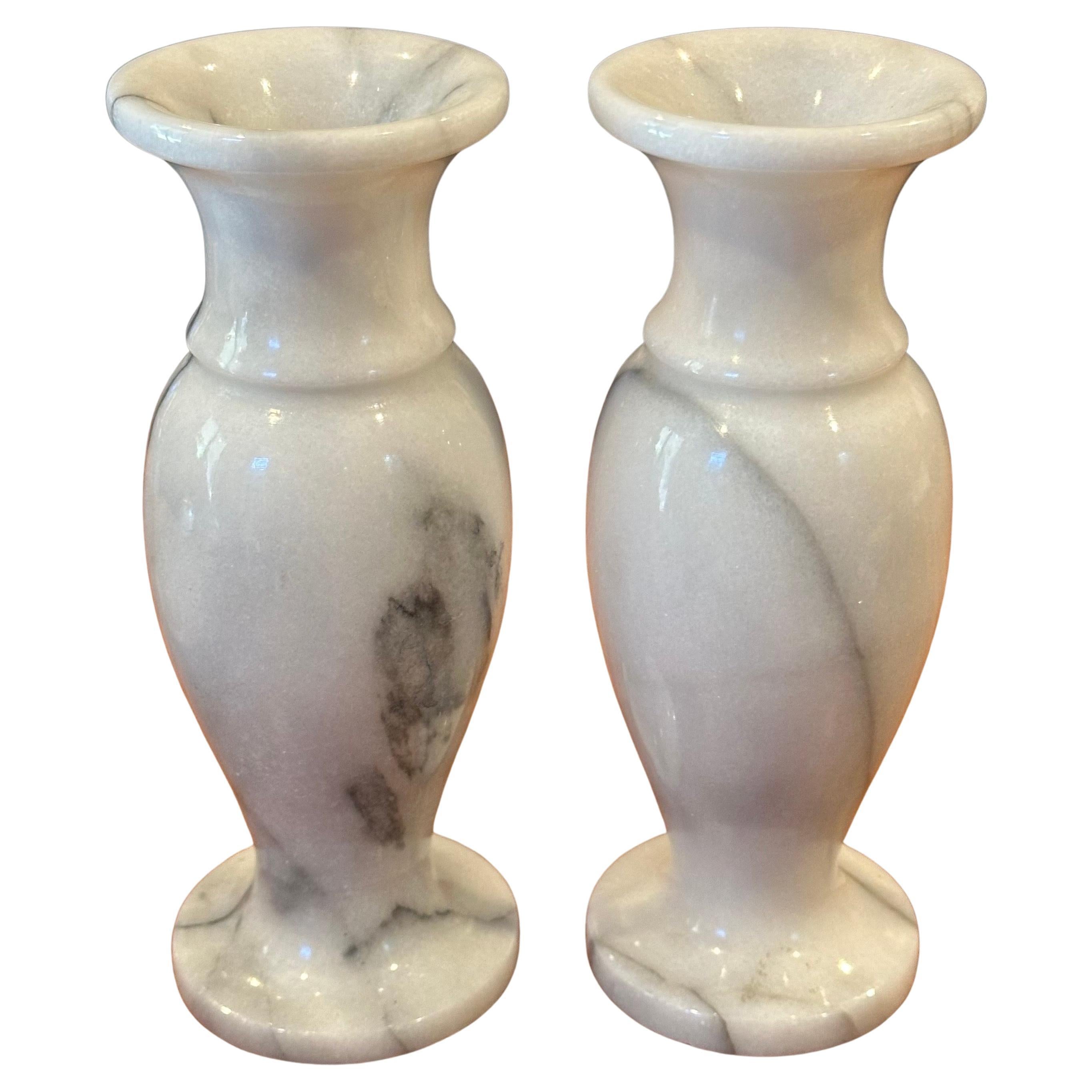 A nice pair of post-modern Italian carrara marble vases, circa 1970s. Gorgeous black veins of marble throughout each vase. The pair are in very good vintage condition with no chips or cracks and measure 3