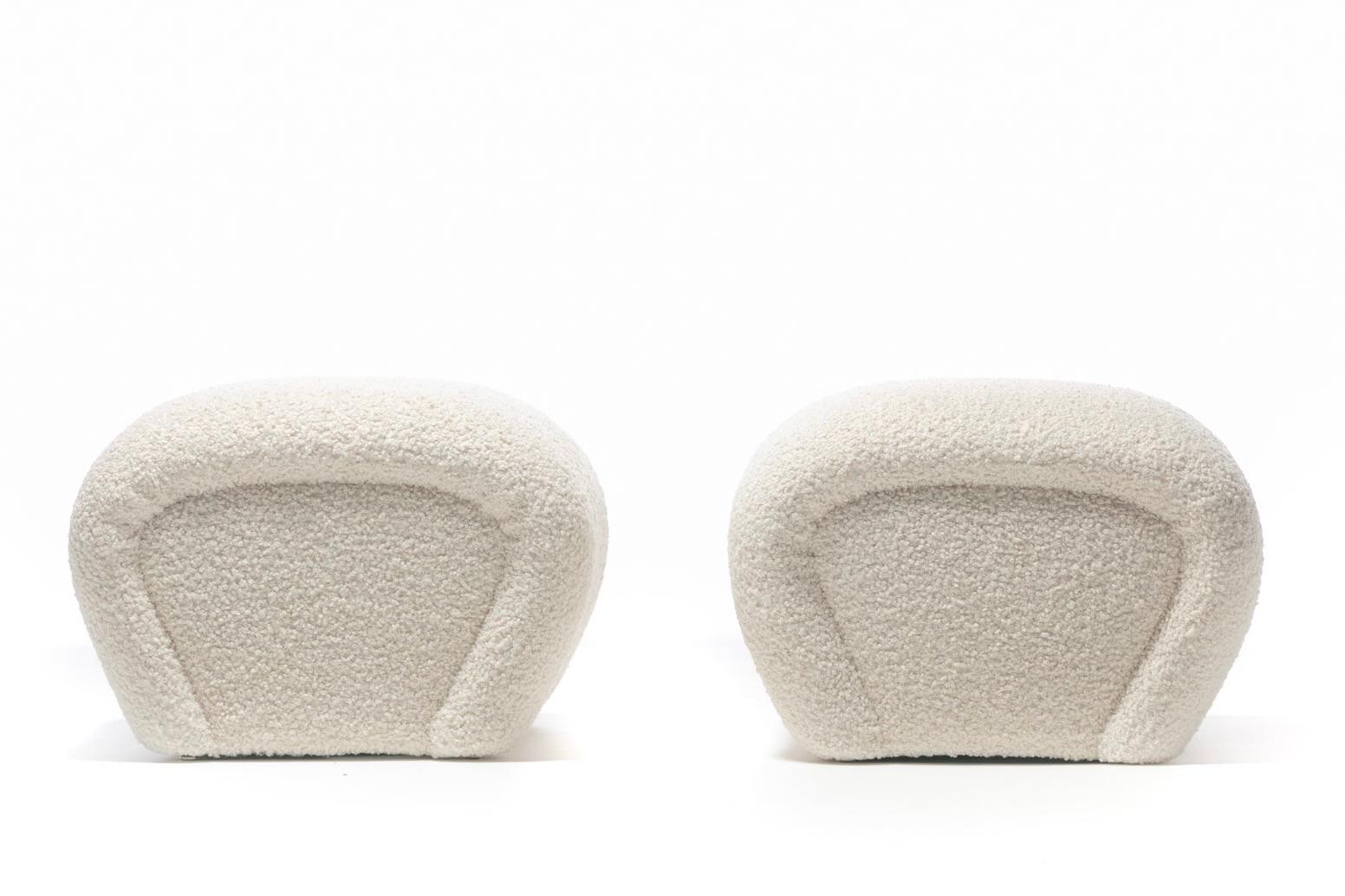 Curvy and soft Postmodern sculptural ottomans freshly reupholstered in plush highly durable ivory bouclé fabric. Reminiscent of Karl Springer's iconic Waterfall Ottomans or Benches, the ottomans' sides curve in a similar waterfall fashion sloping