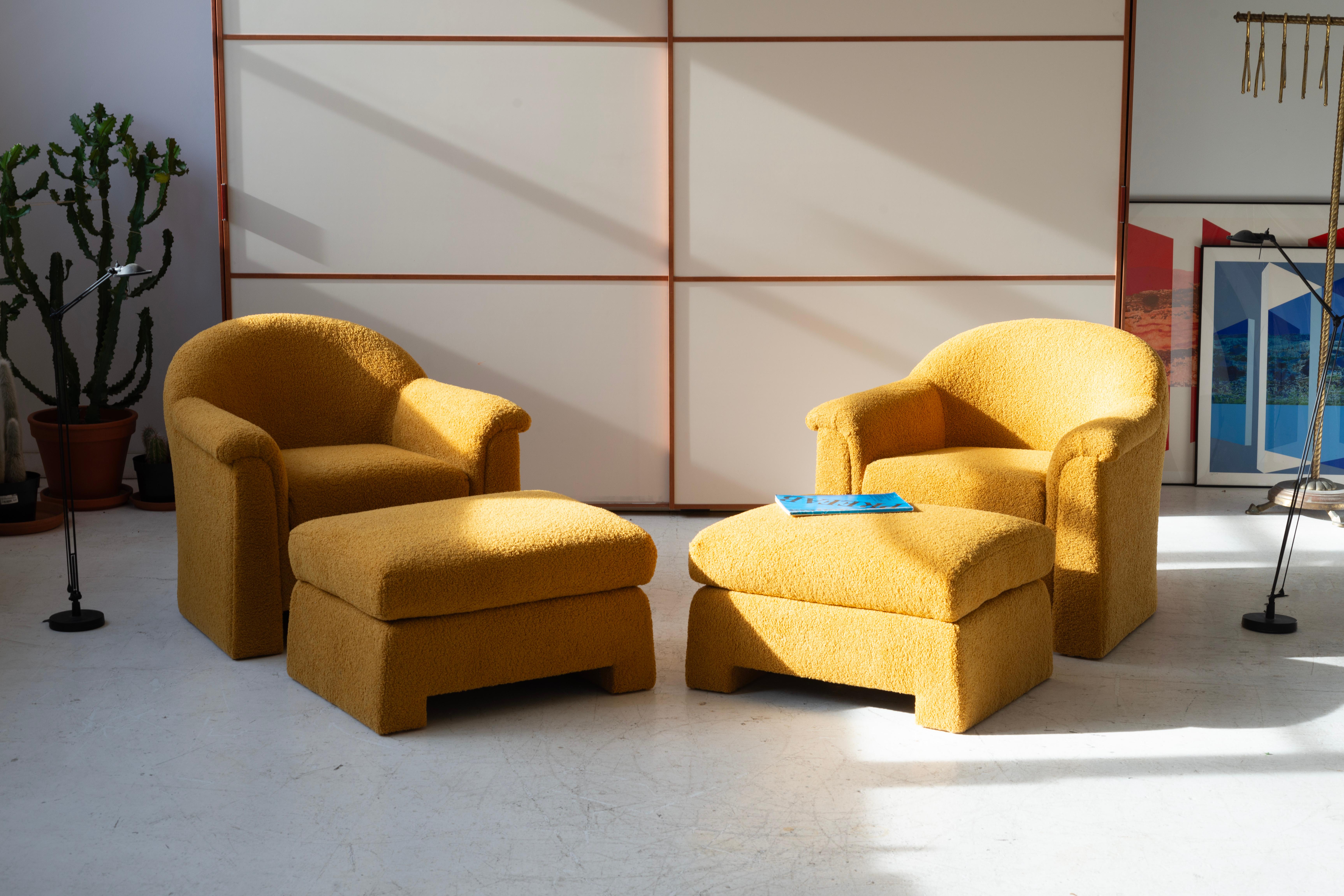 These post-modern lounge chairs and matching ottomans feature a sleek, minimalist design with gentle curves, embodying contemporary style. Upholstered in high-quality ochre-colored boucle, they offer a warm, textured look. Filled with new foam,