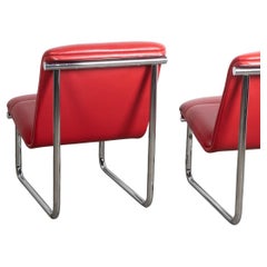 Pair of post modern red leather and chrome lounge chairs