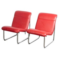 Pair of post modern red leather and chrome lounge chairs