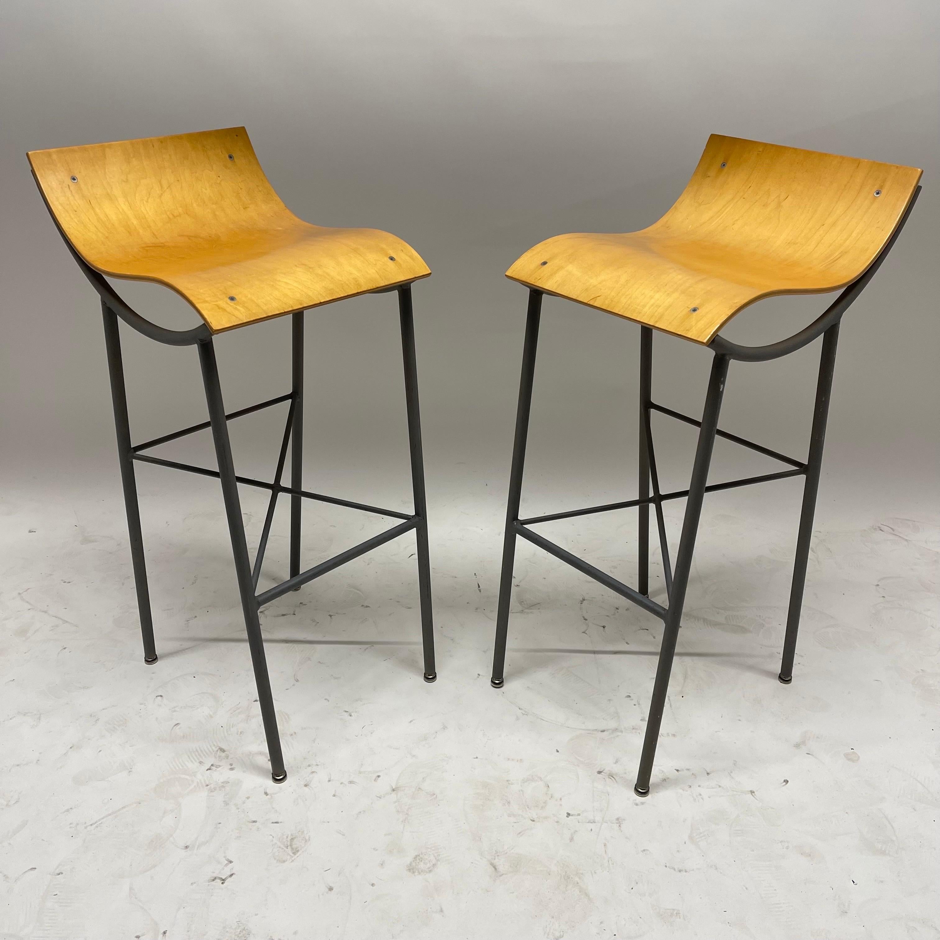 Unique pair of postmodern barstools, rendered in a sculptural architectural welded steel powder coated frame with a hand molded bent plywood seat, circa 1980s, Italy.