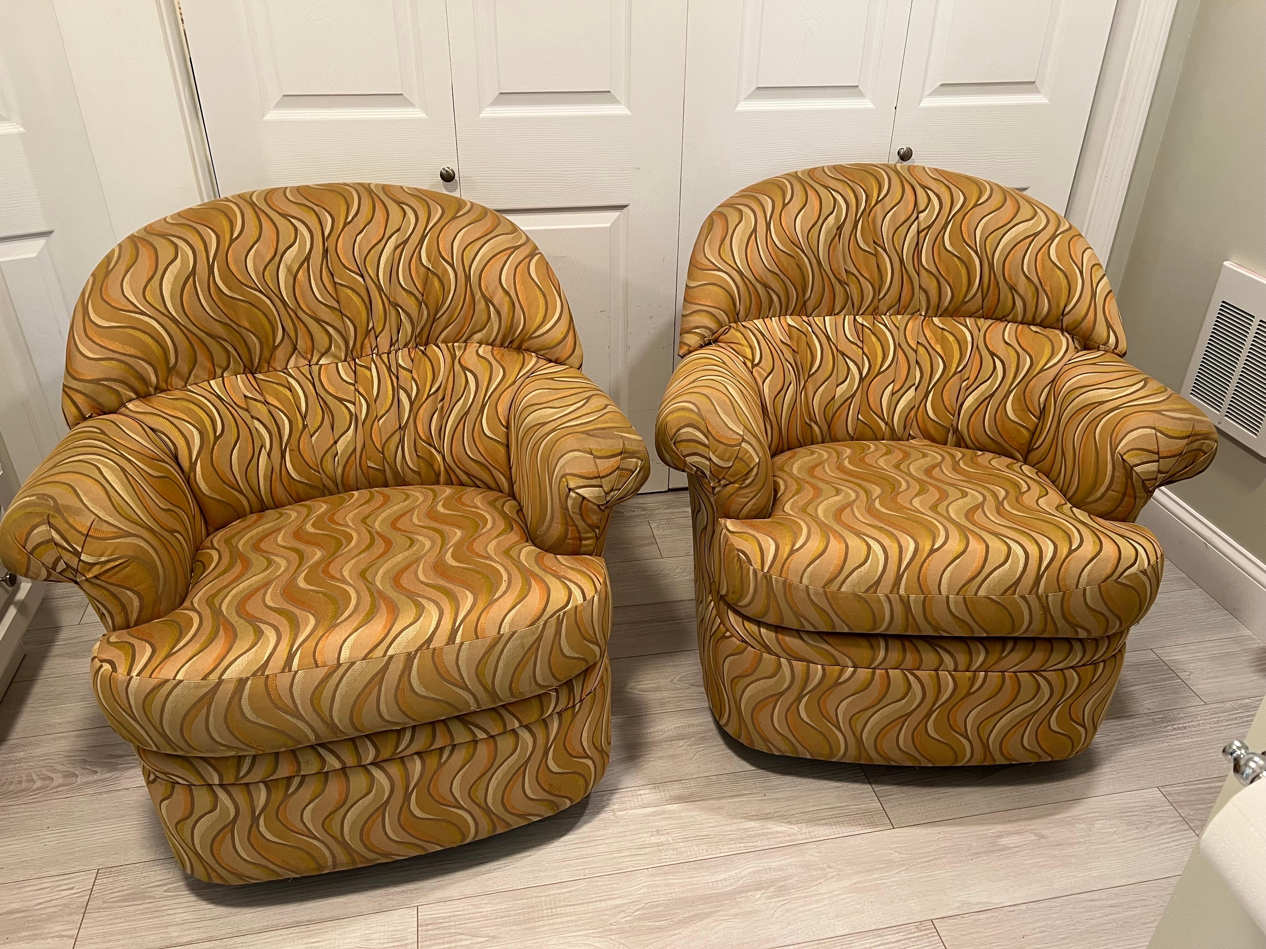 Pair of 1980's Post Modern swivel club chairs. They both swivel and Rock. Super comfortable with nice supportive back. Wear consistent with age and use, some light stains to fabric. Use as is or recover in desired fabric
Overall Measurements: Total