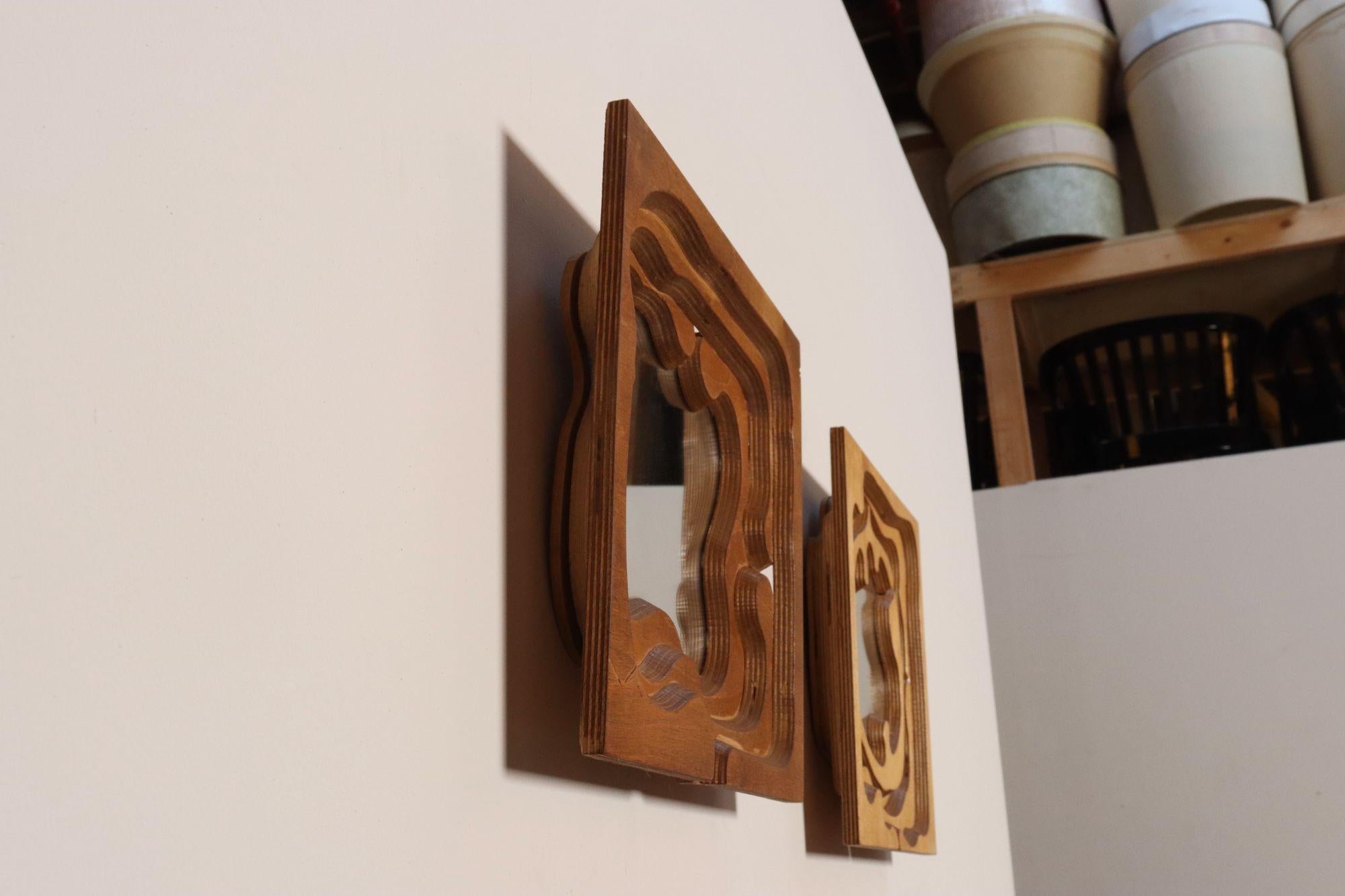 Set of two 3D wooden sculptural puzzle mirrors made in 1980 by Brooklyn, NY Feminist Expressionist Artist and Pratt graduate, Bernette Rudolph (B. 1929, Bronx, NY).
Sensuality is a common theme in Rudolph's work, and these designs are no exception.