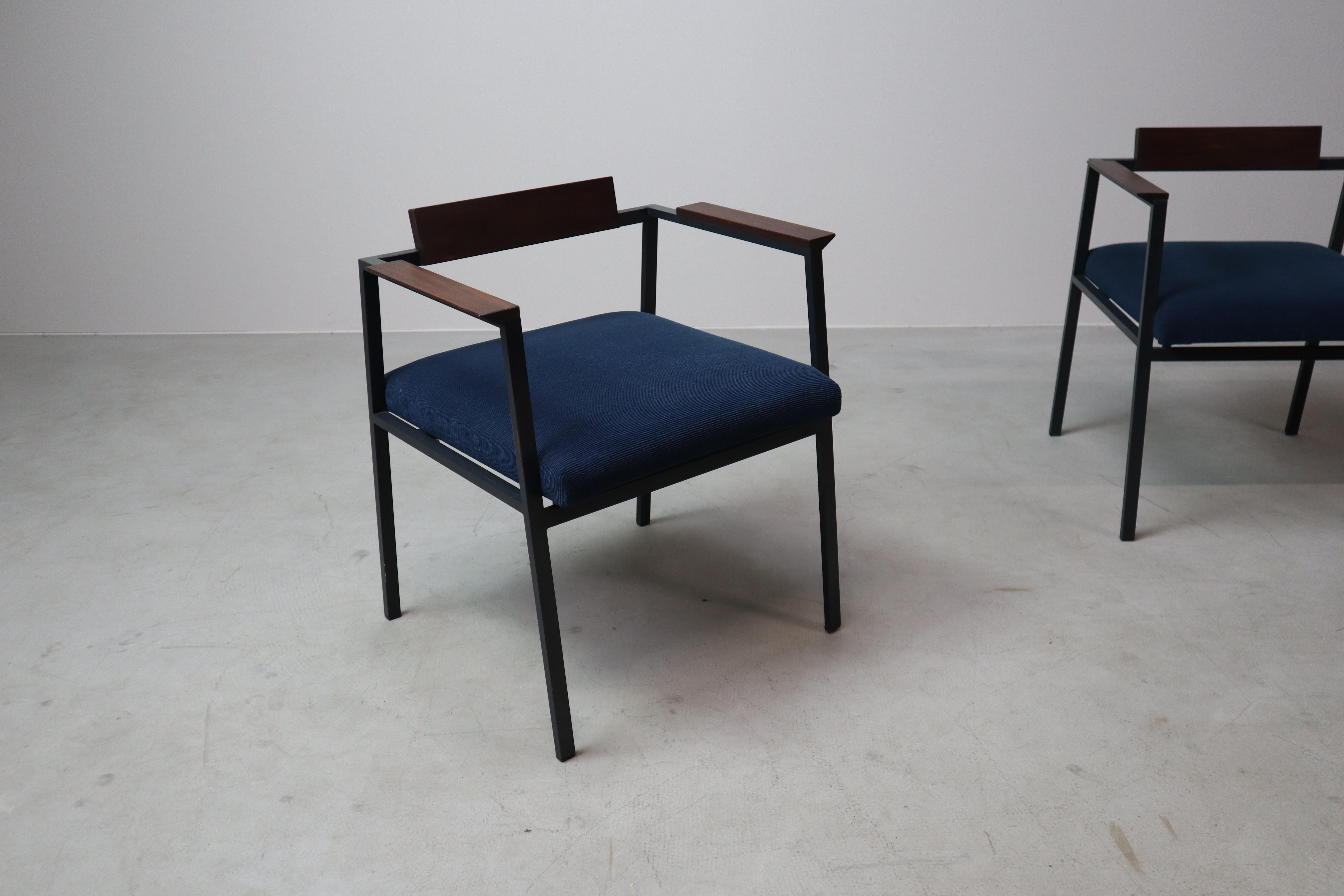 This pair of vintage armchairs showcases the bold geometry and material contrasts characteristic of postmodern design. Produced in the late 1970s or early 1980s, the chairs feature a black lacquered steel frame with sharp, architectural lines,
