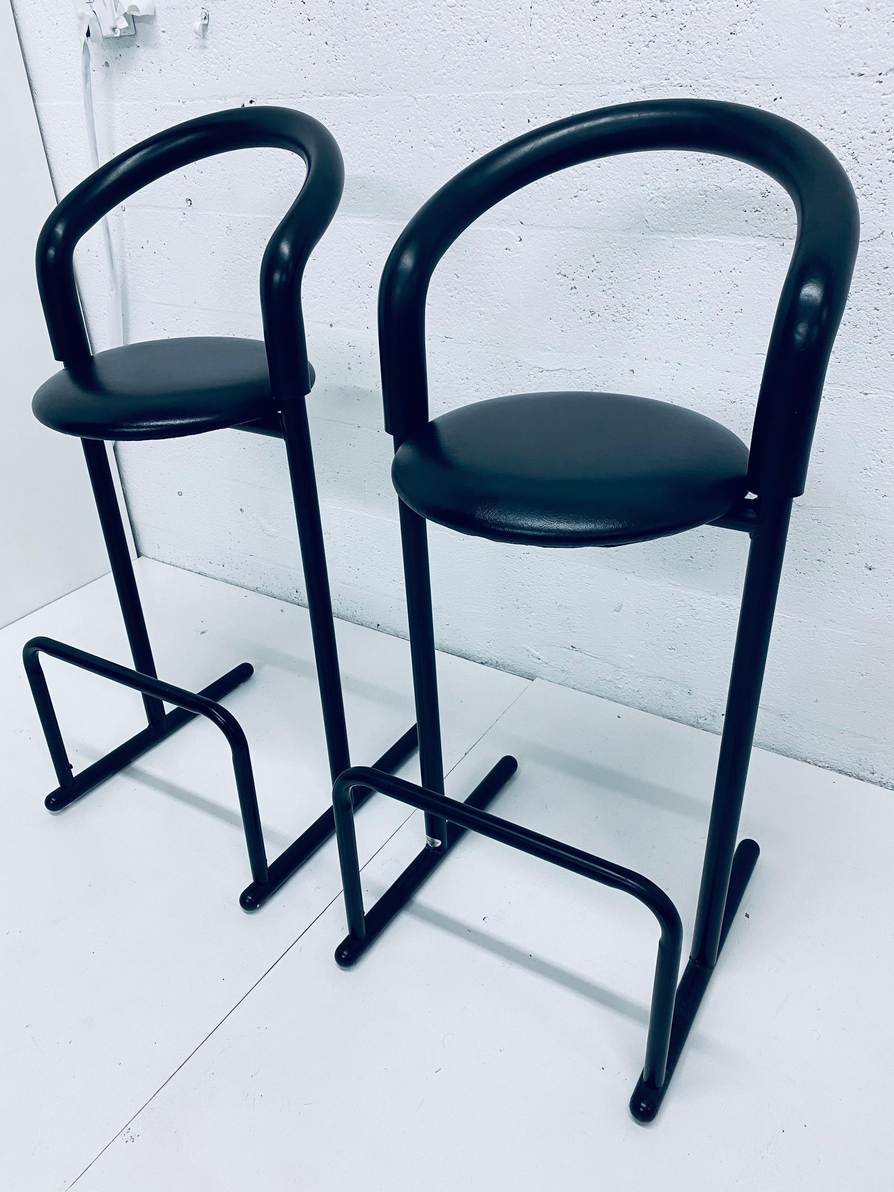 Postmodern 1980s designed tubular bar chairs / stools with foam backs and Naugahyde cushions in all black manufactured by Les Industries Amisco, Canada.