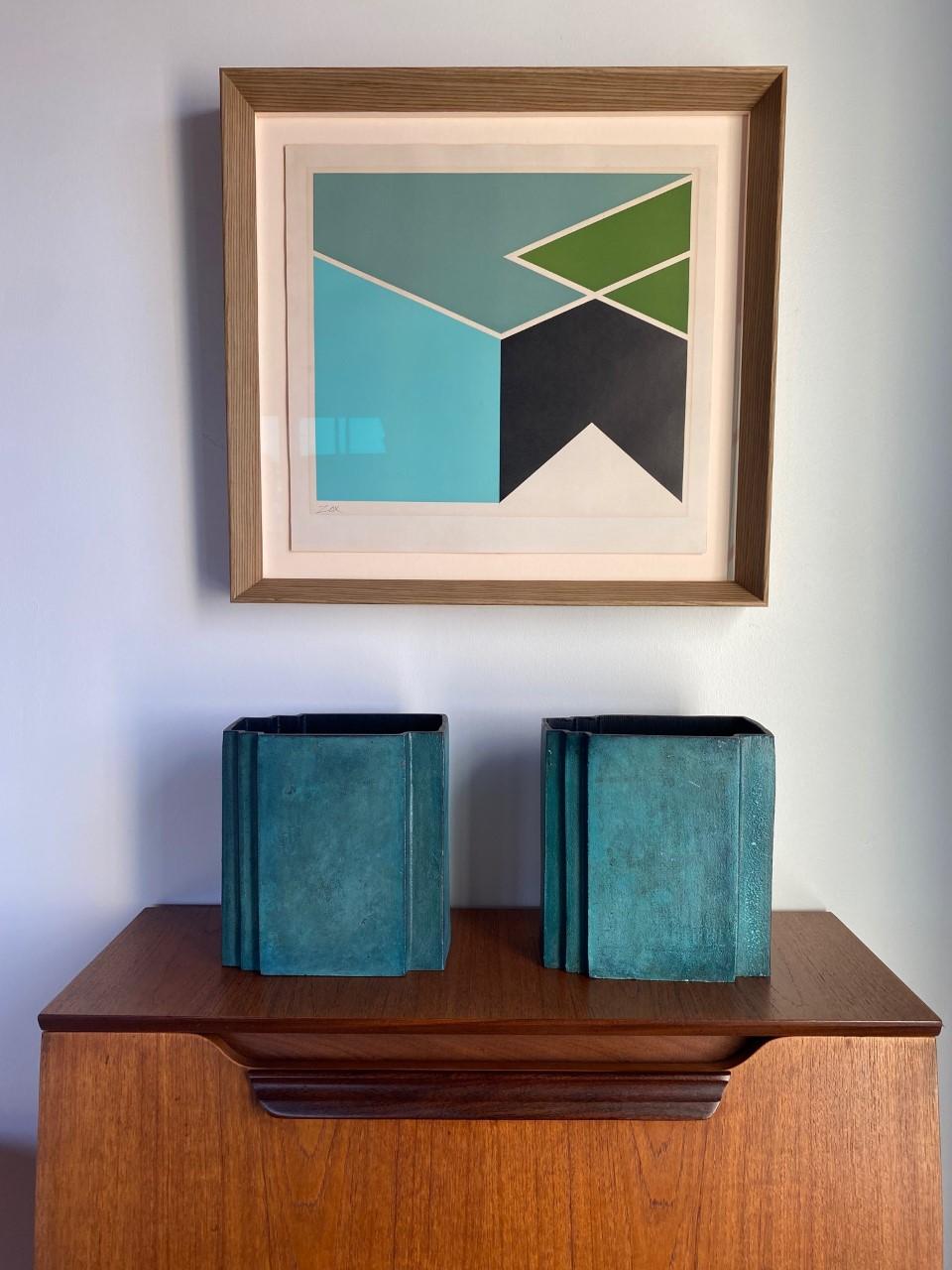 Pair of Incredibly graphic brass postmodern sculptural vases. The vessels are rectangular, with simple lines that enhance the pair from functional to sculptural. These construction of these brass pieces is defined and bold. Parallel lines play